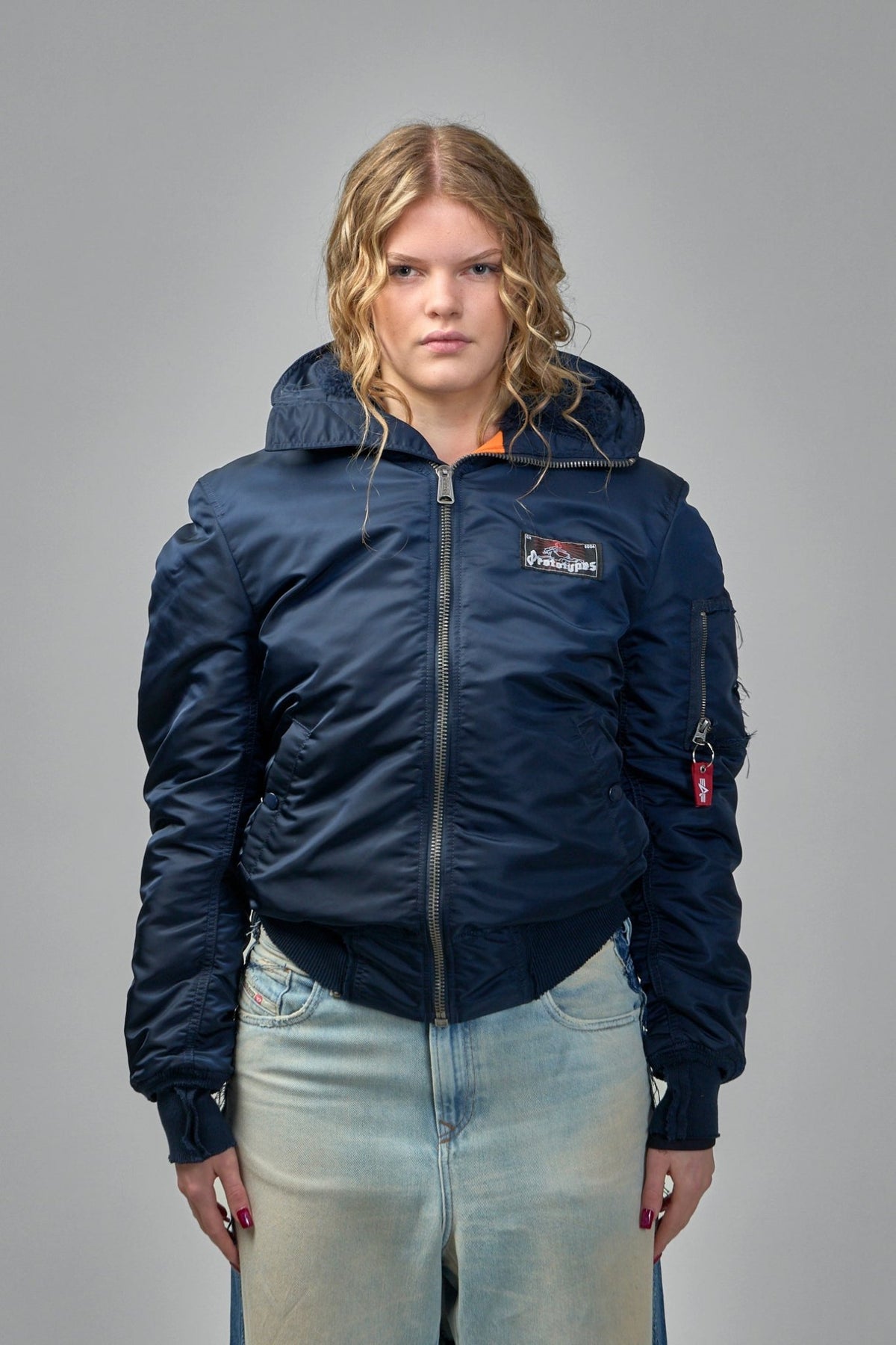 Model wearing Prototypes navy bomber jacket with casual styling, view 9
