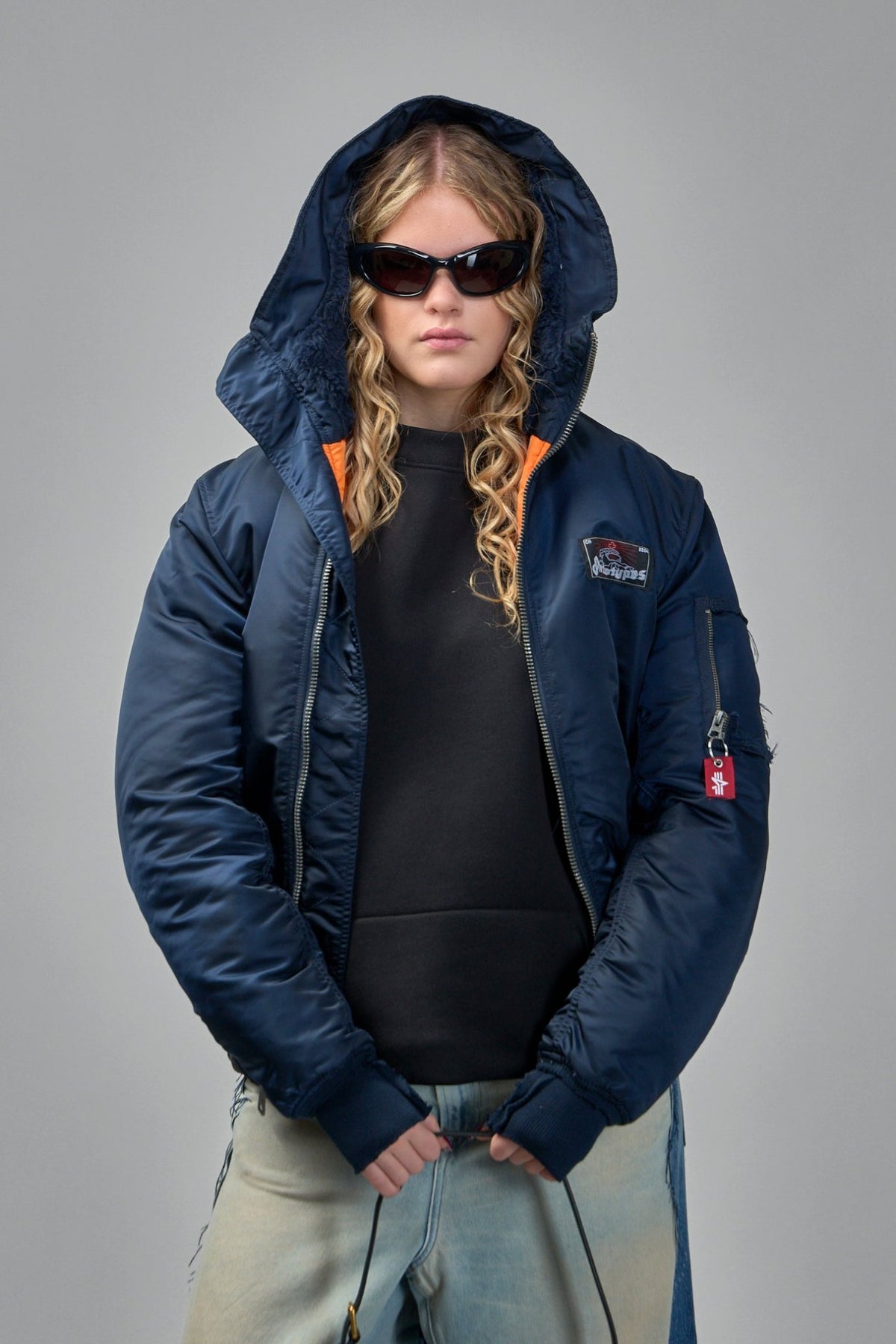 Model wearing Prototypes navy bomber jacket with casual styling, view 8