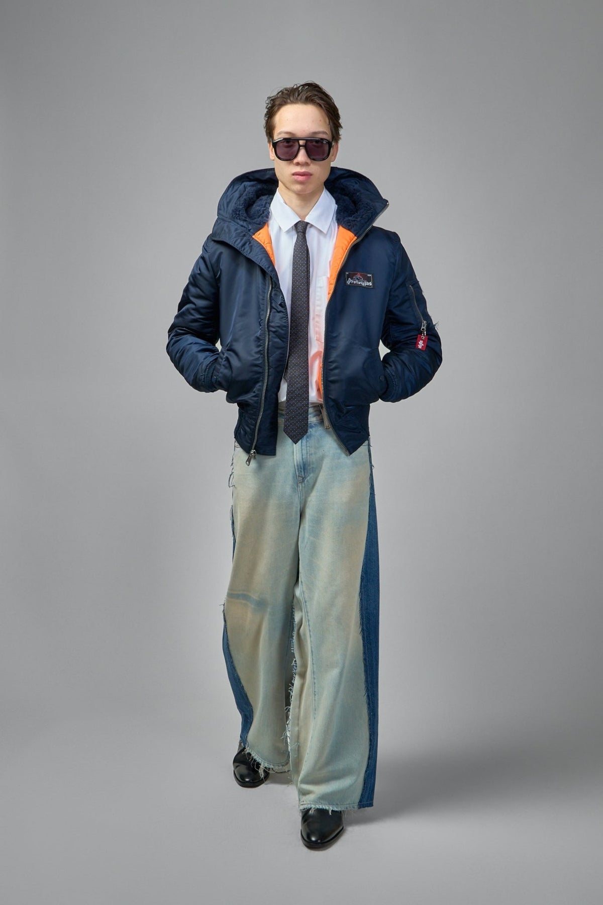 Model wearing Prototypes navy bomber jacket with casual styling, view 7