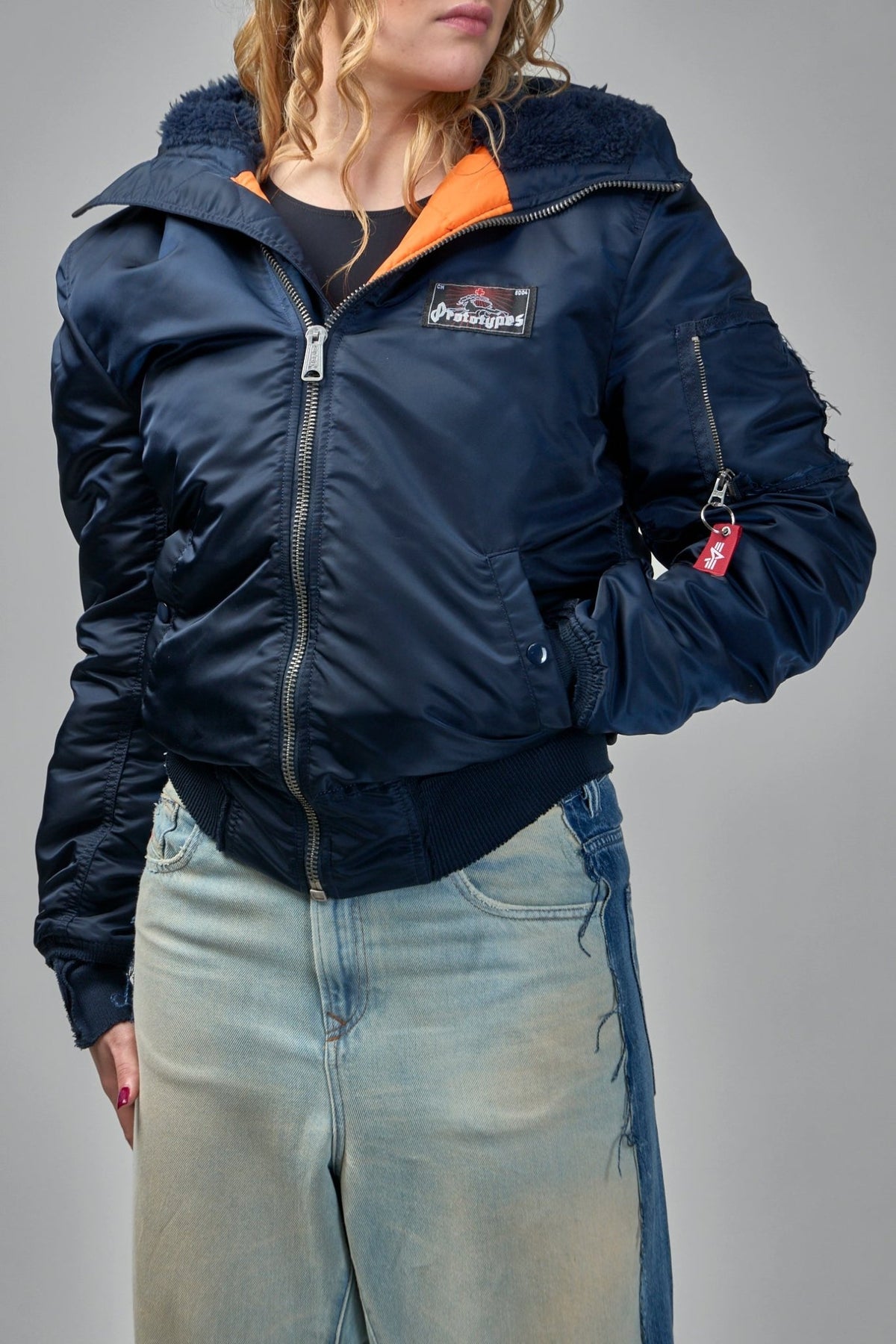 Model wearing Prototypes navy bomber jacket with casual styling, view 11
