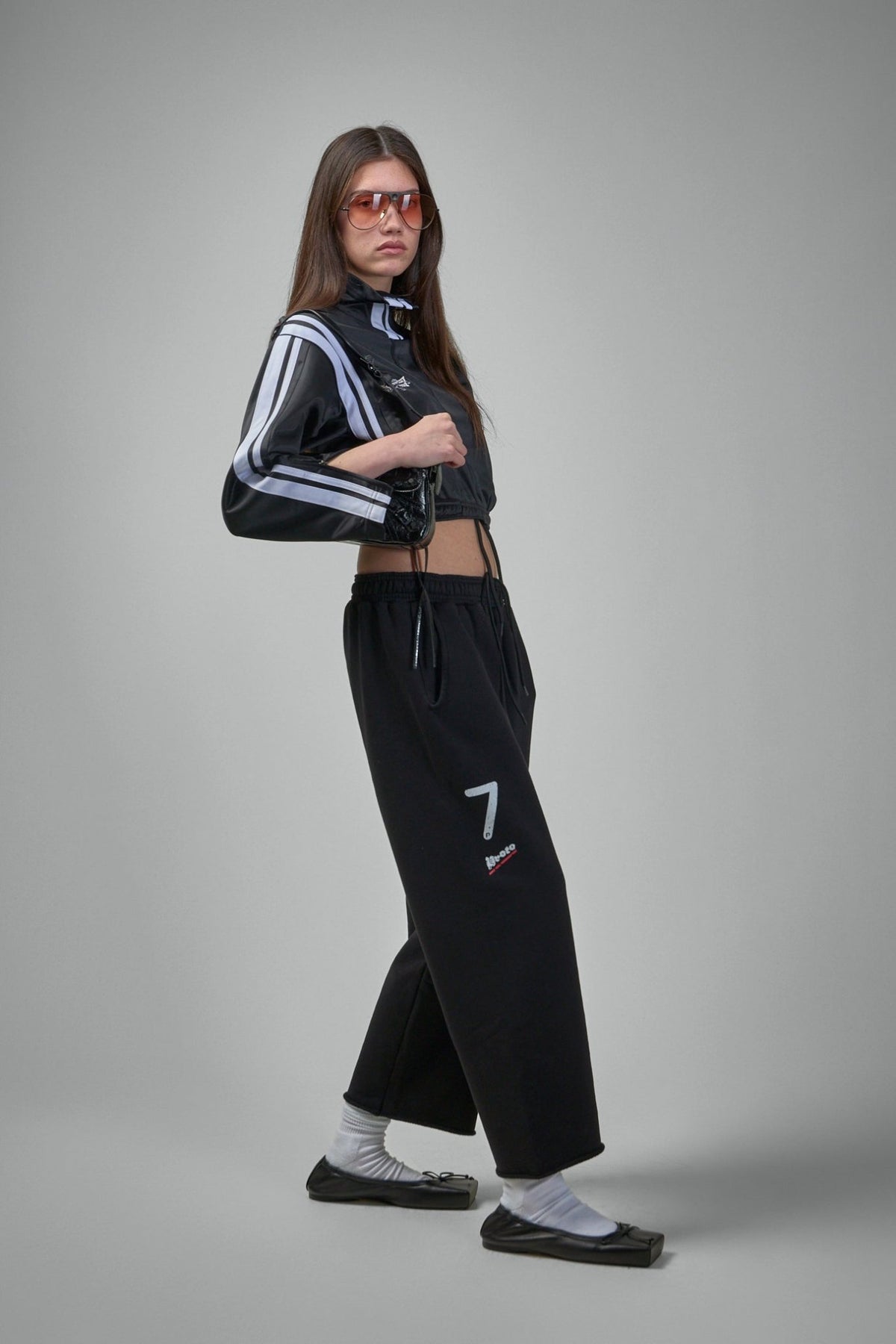 Close-up of Prototypes logo print detail on cropped sweatpants