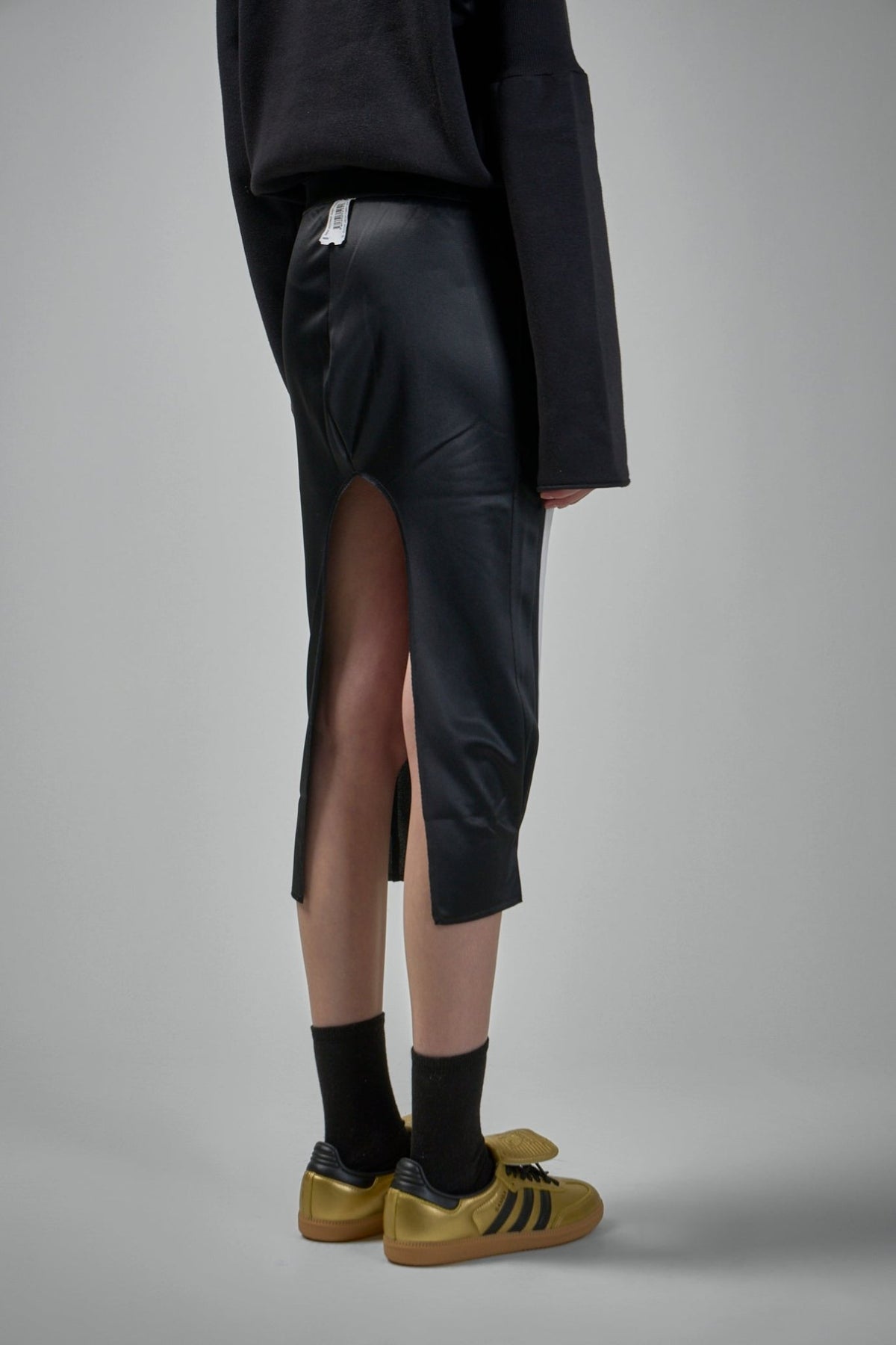 Side view showing flattering pencil silhouette and pocket placement