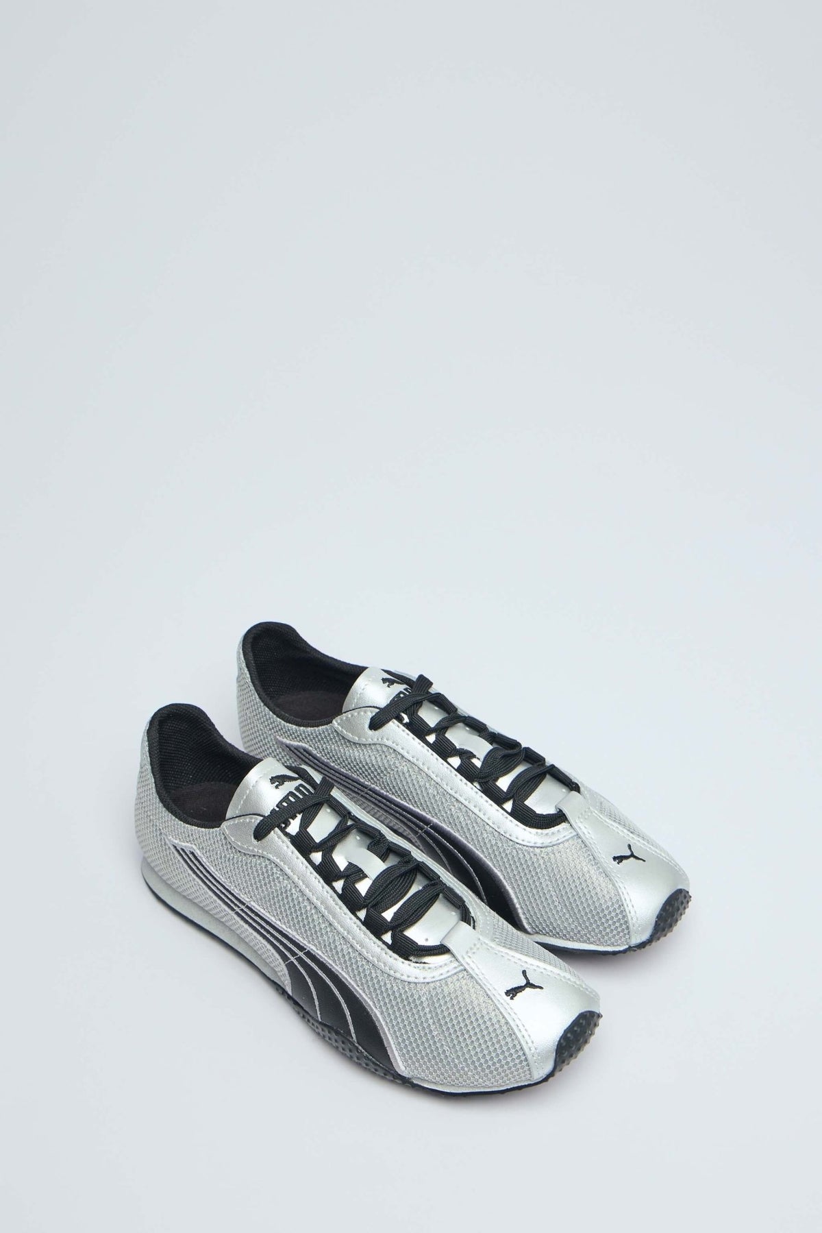 Side view of chrome sneakers showing mesh panels and textured sole
