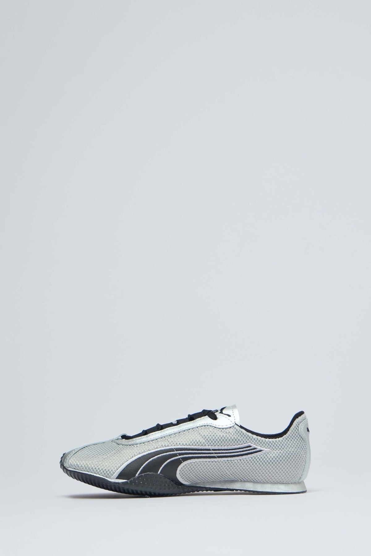 Close-up of Puma logo on metallic sneaker tongue