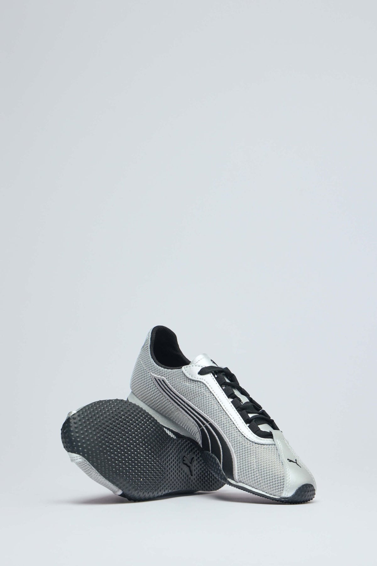 Detail shot of textured rubber sole on metallic sneakers