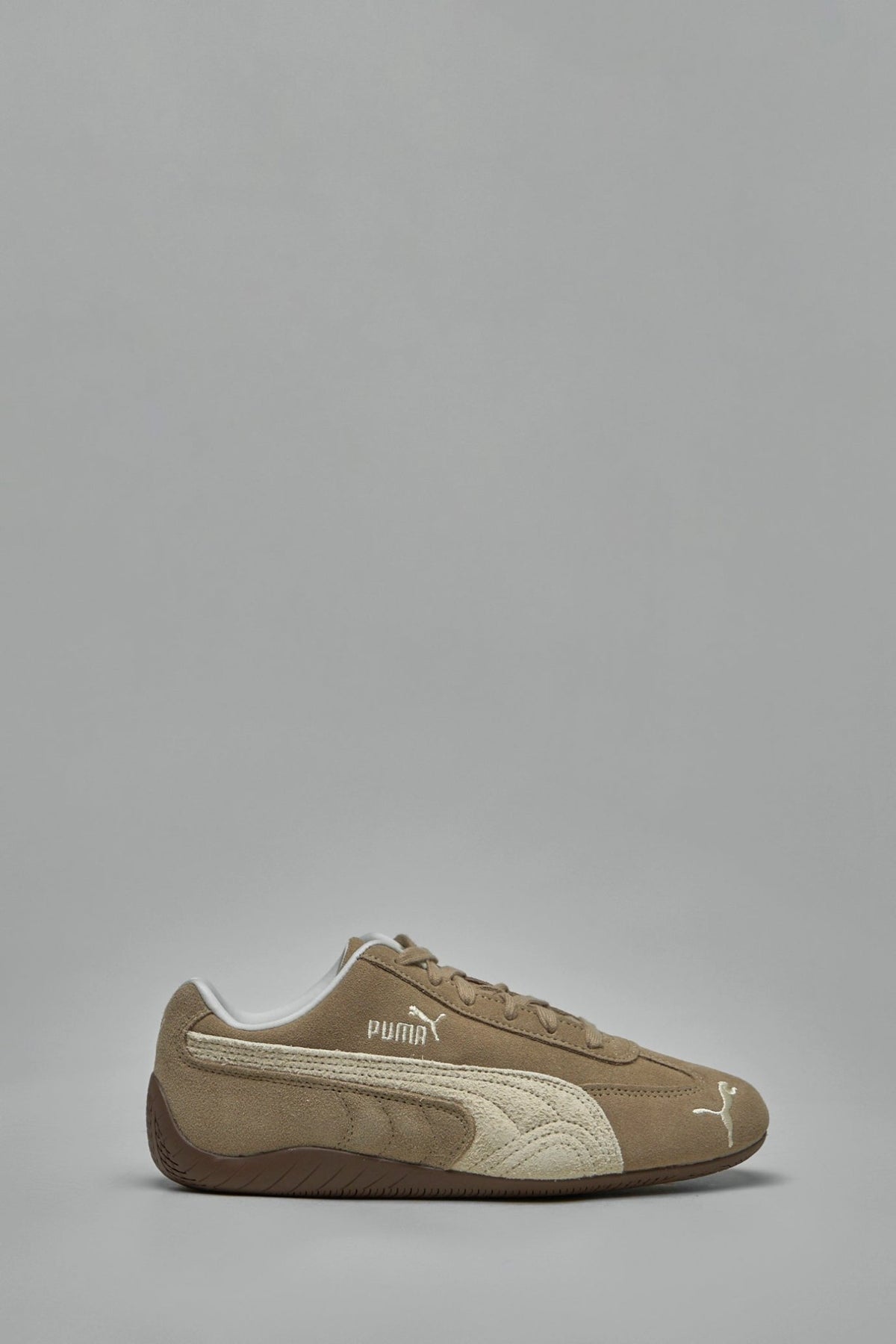 Puma low top sneakers in brown suede with white logo stripes