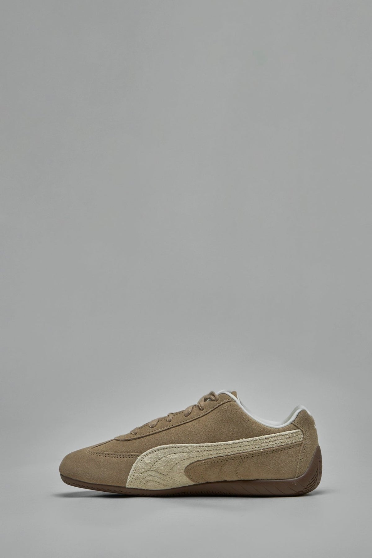 Close-up of brown suede material and white Puma branding