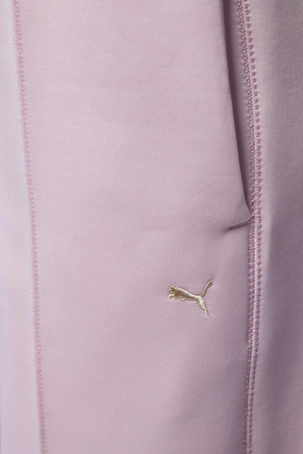Detail shot of drawstring waist and elastic waistband on Puma track pants