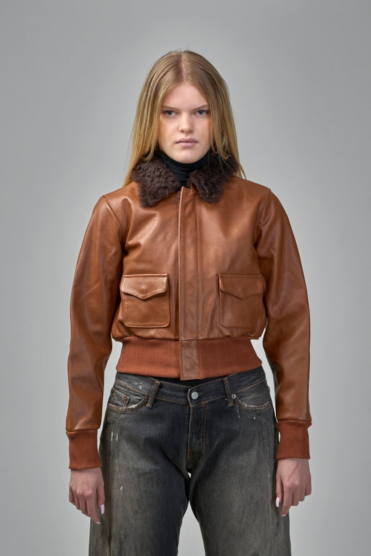 Close-up of R13 bomber jacket showing pebbled leather texture and ribbed cuffs