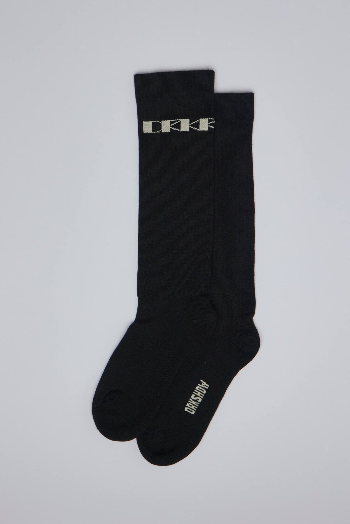 Close-up of Rick Owens DRKSHDW knee-high socks showing text branding on sole