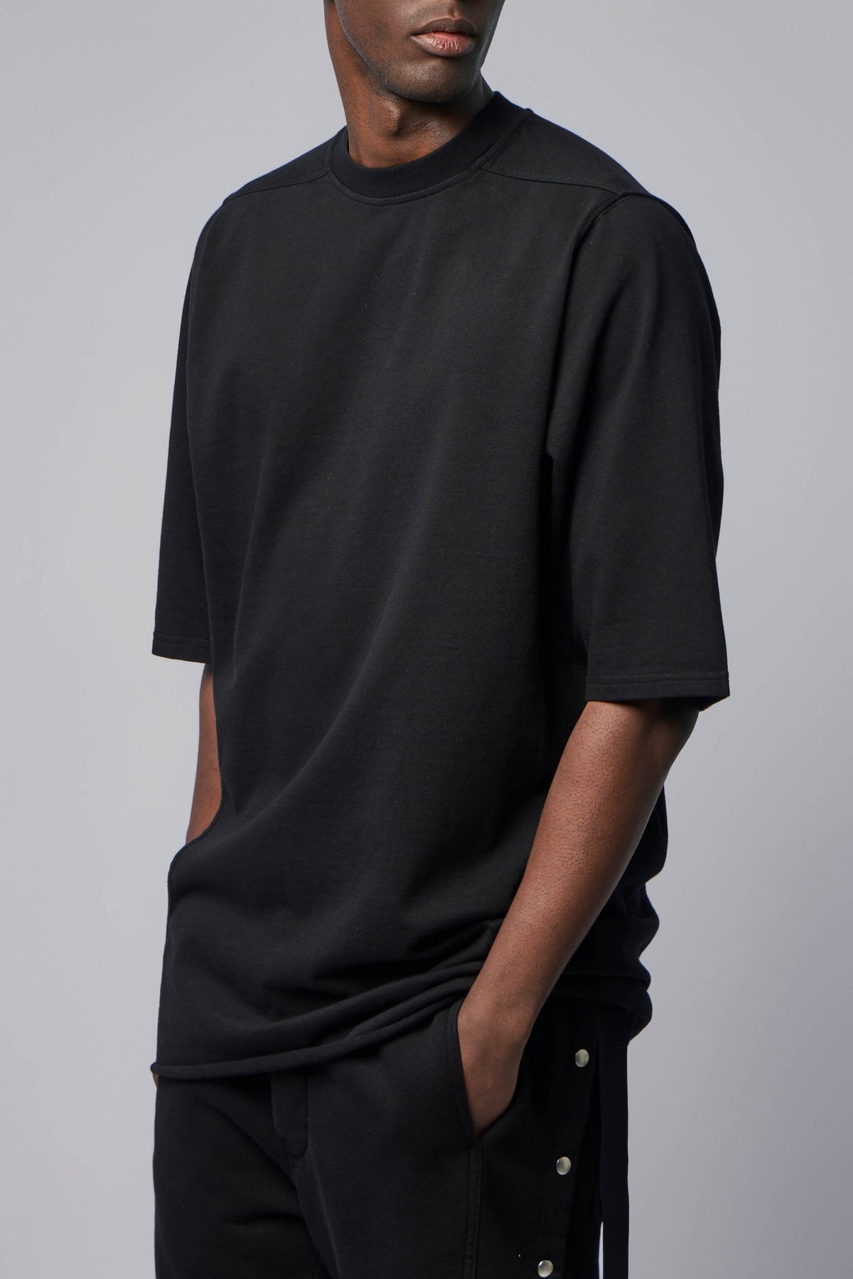 Model wearing Rick Owens DRKSHDW black t-shirt showing relaxed fit and proportions