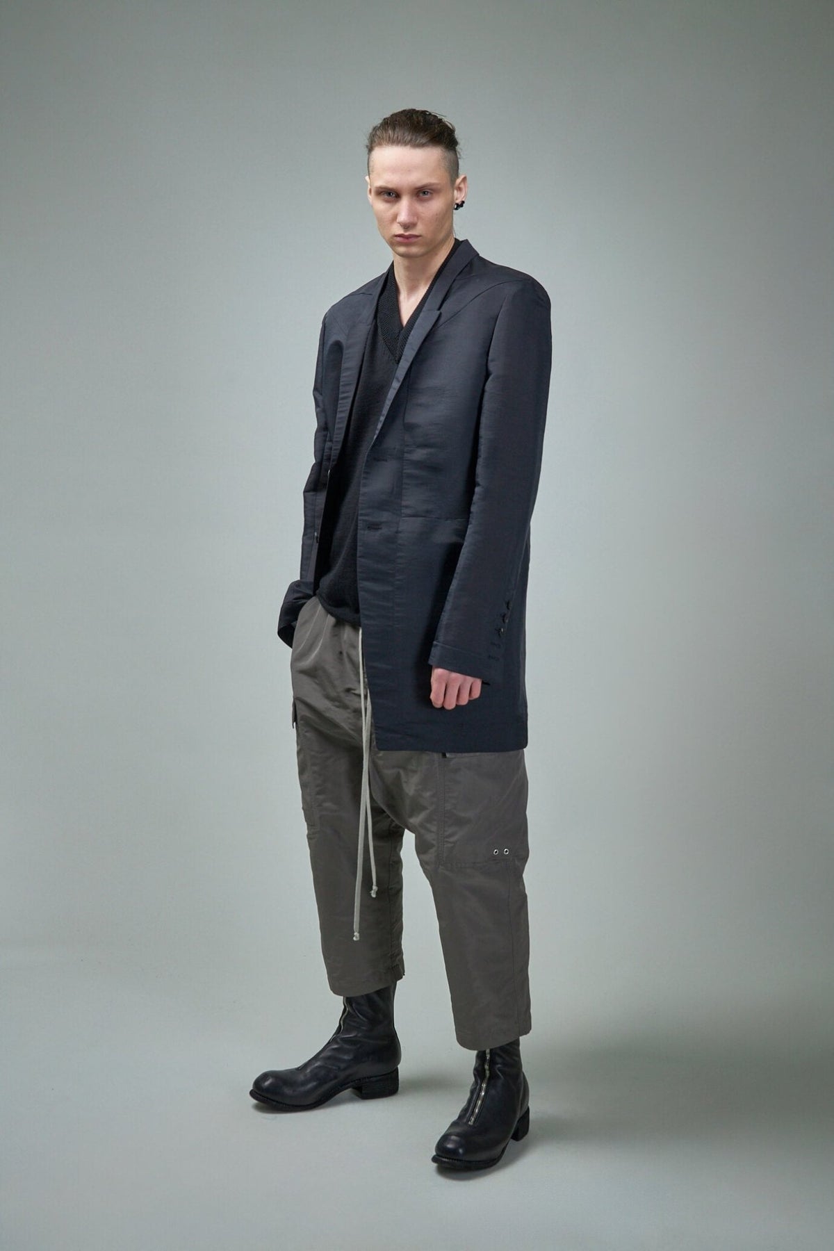 Close-up of Rick Owens Giacca Lido jacket showing multi-pocket design and buttoned cuffs