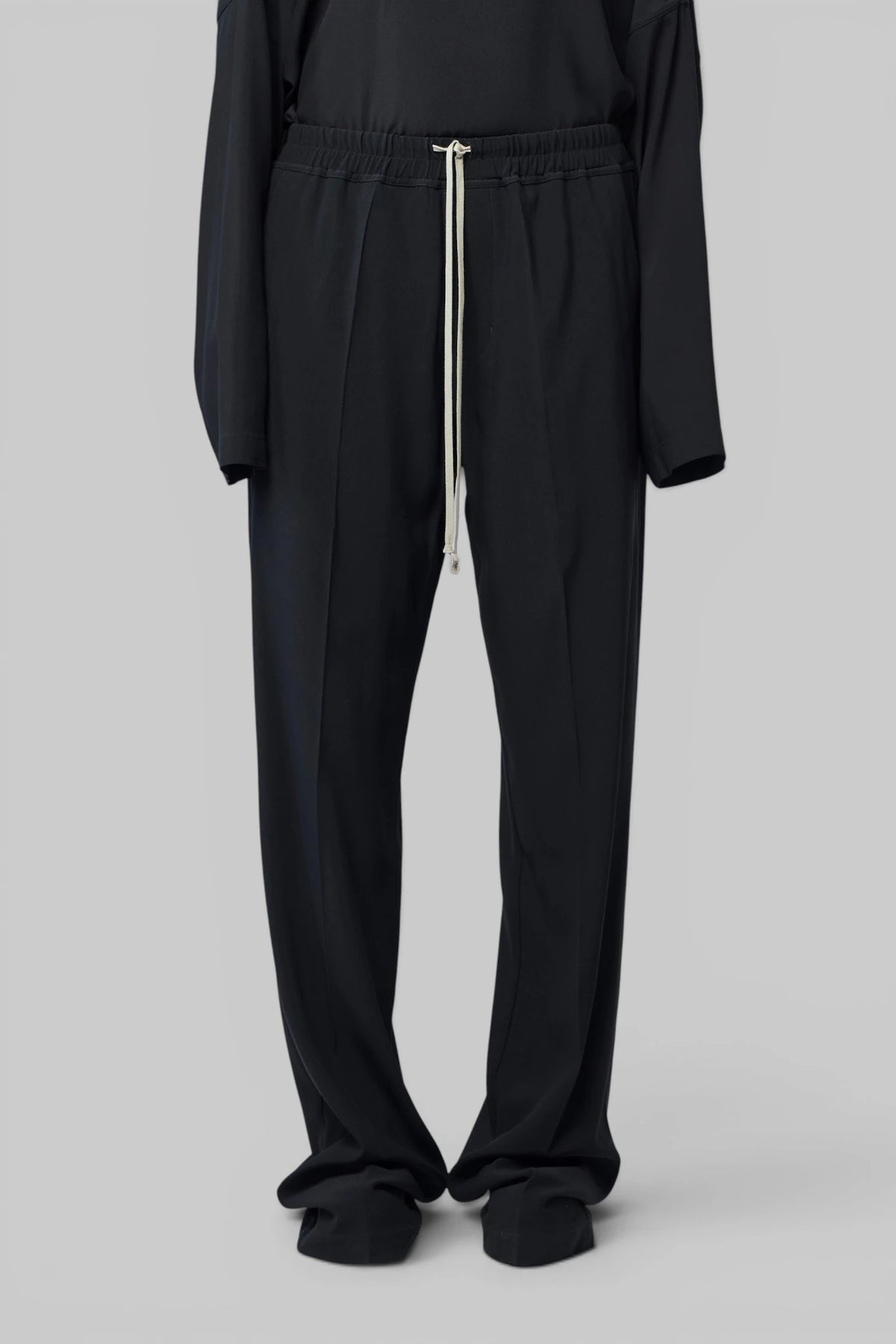 Detail of adjustable white drawstring on Rick Owens trousers
