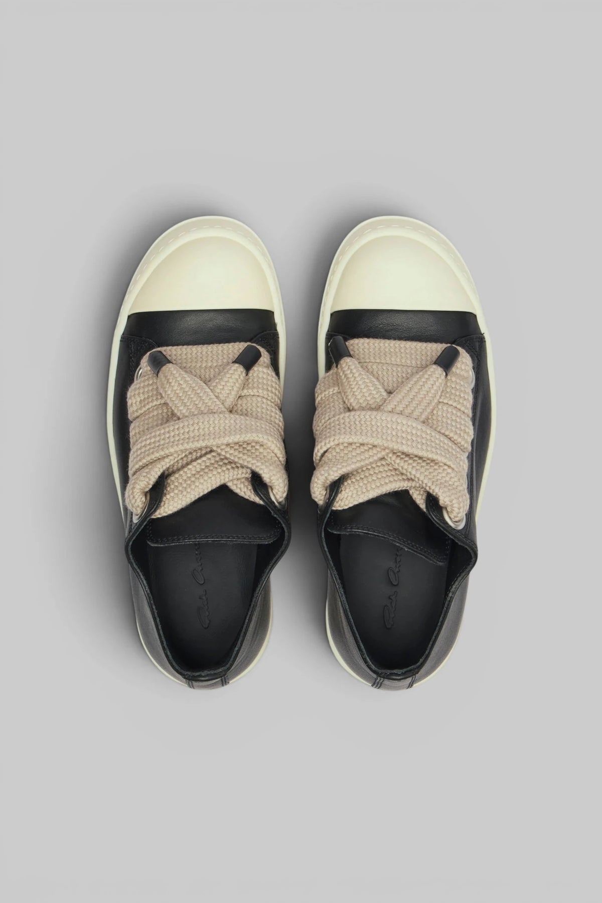 Close-up of contrasting beige laces on Rick Owens low top sneakers