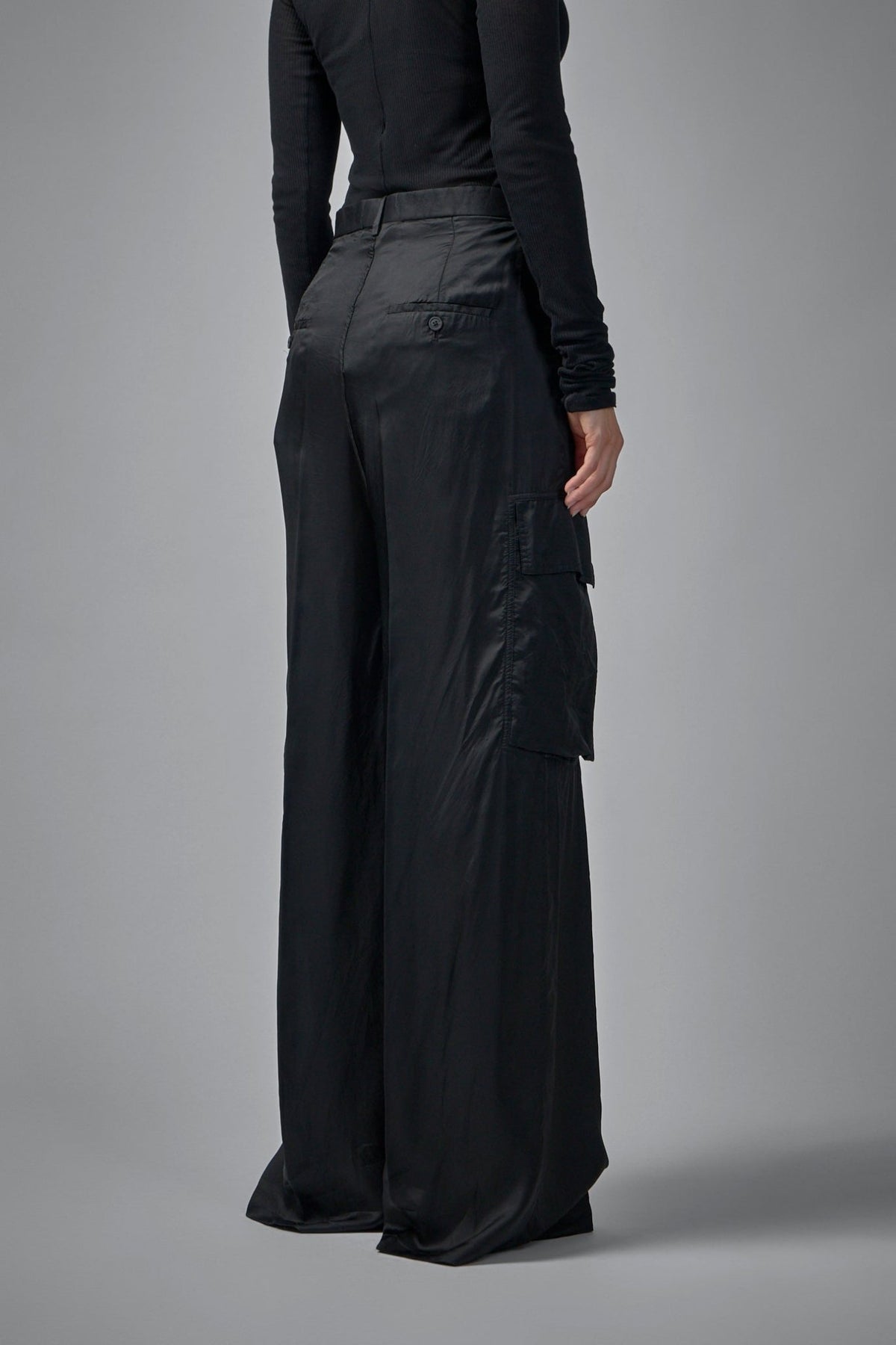 Back view highlighting buttoned pocket and minimal seaming details