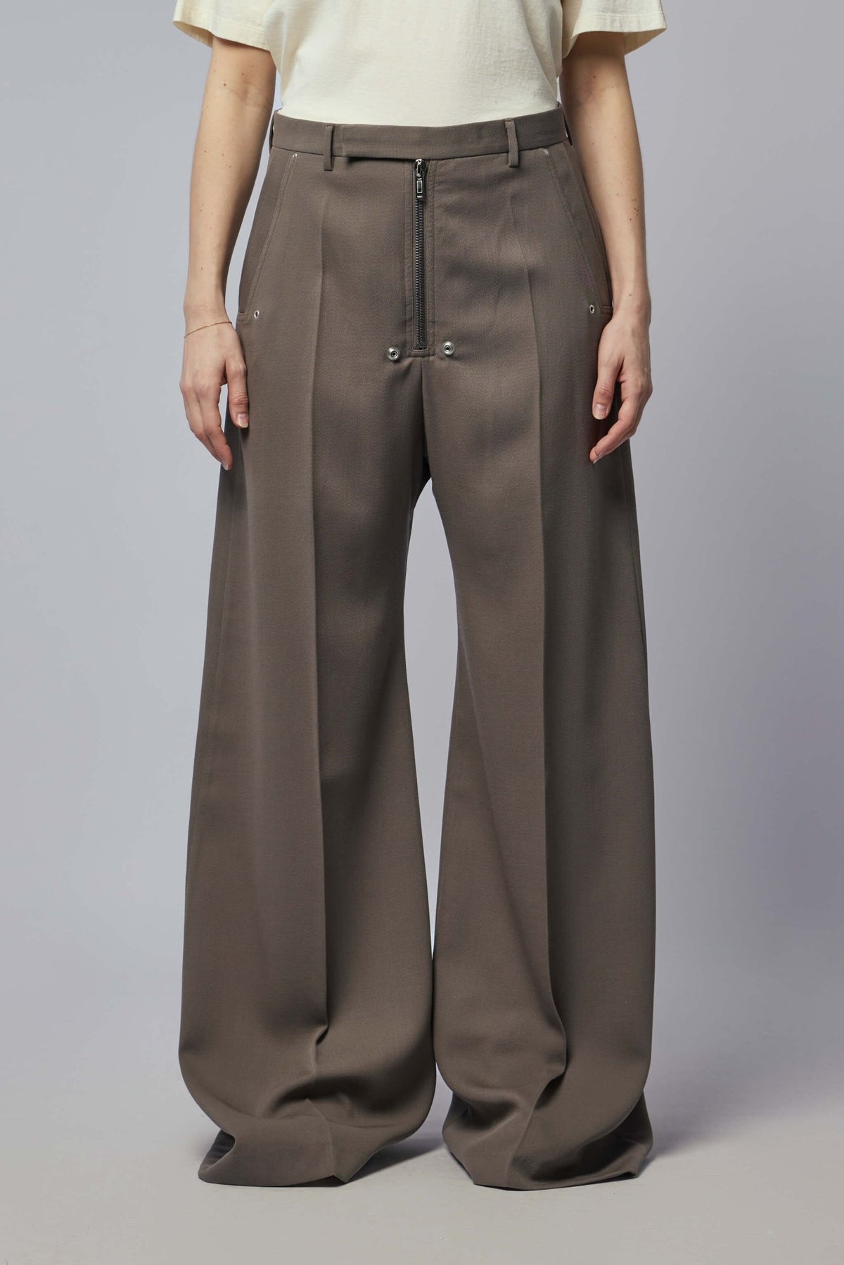 Close-up view of Rick Owens wide-leg pants showing signature zipper and rivet details