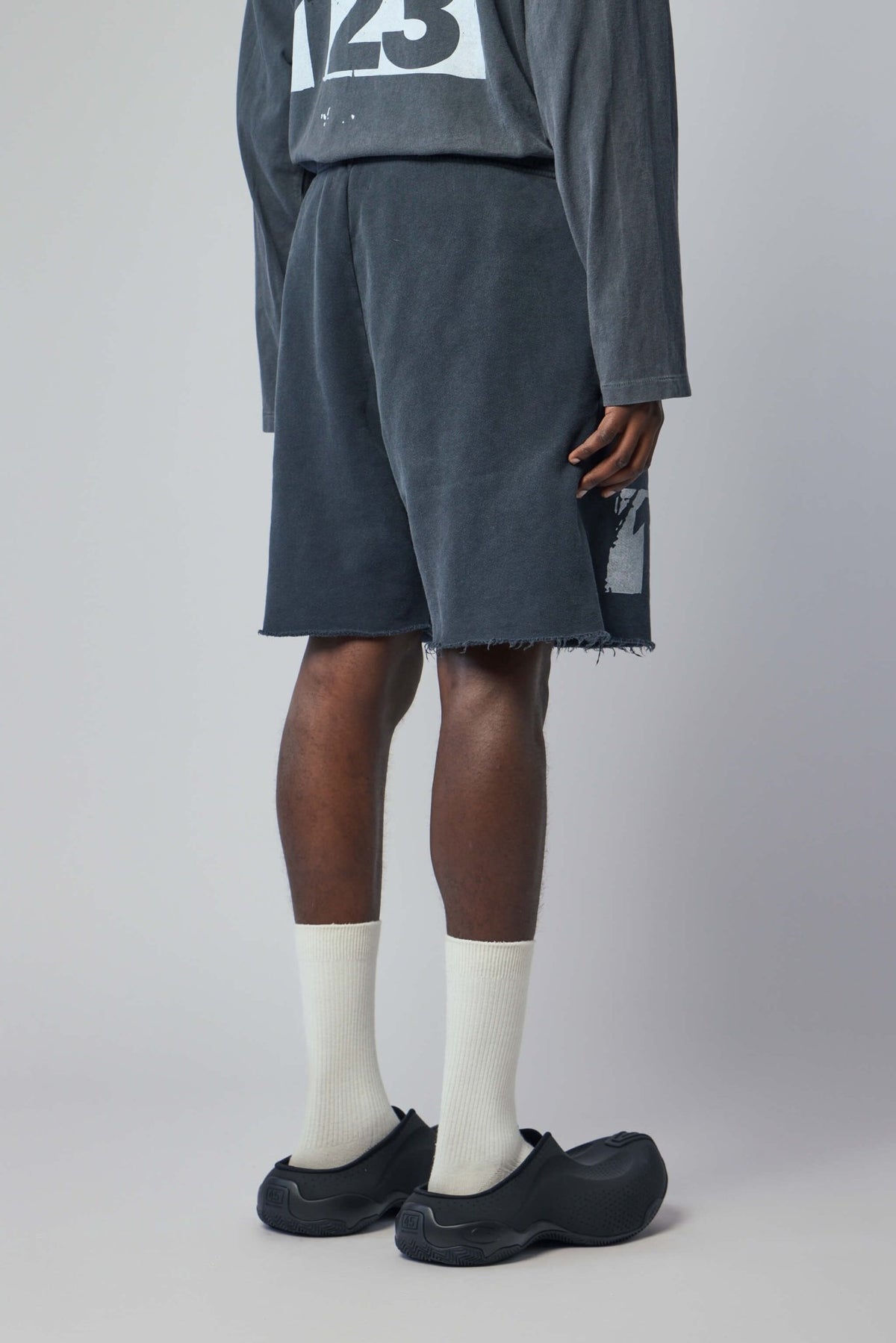 Flat lay styling of shorts with luxury menswear accessories