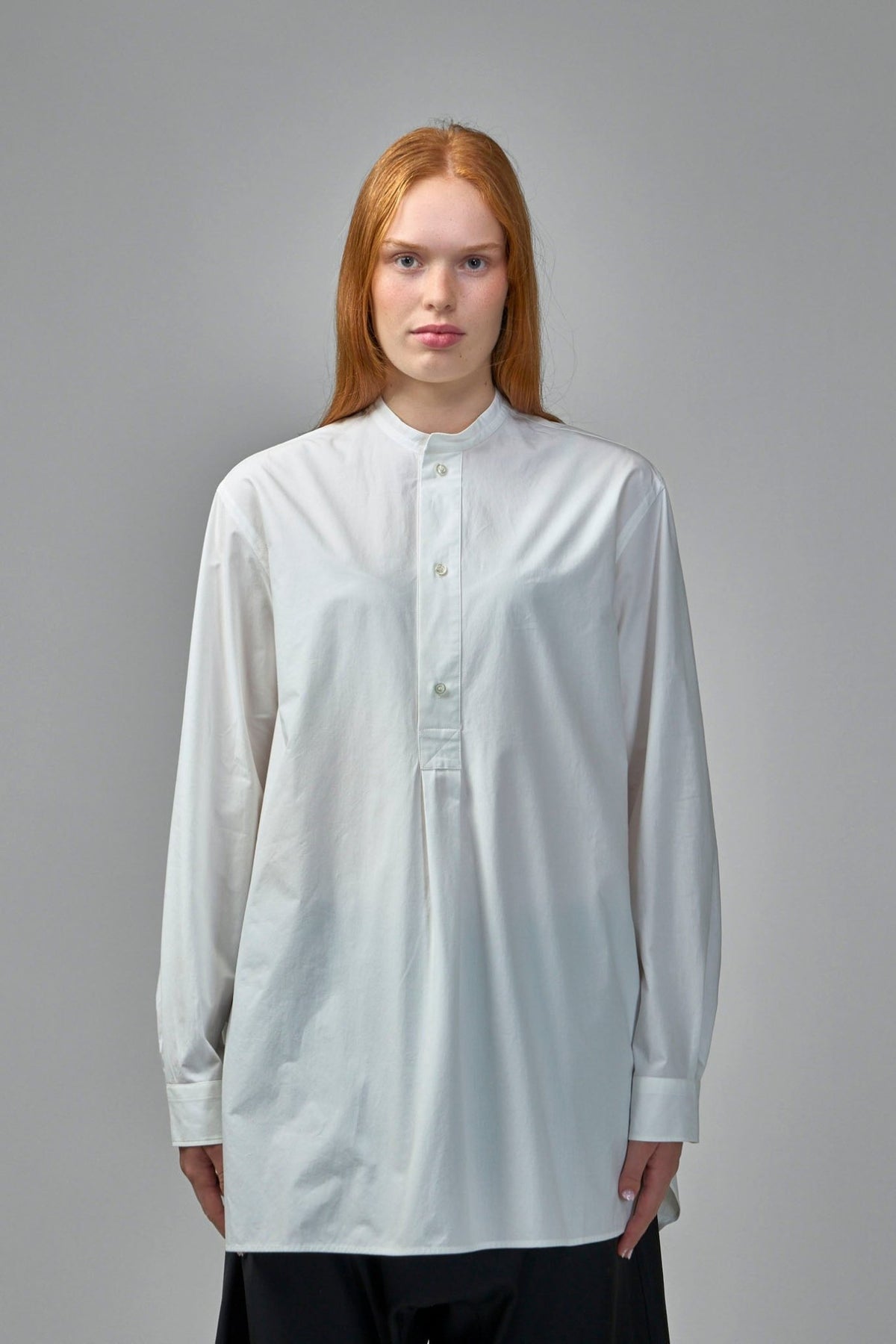 Side view showing relaxed fit and tunic silhouette of designer shirt