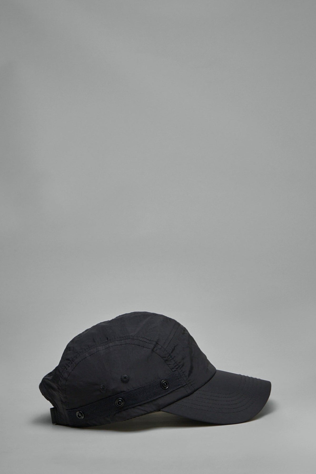 Side profile showing detachable flap feature and sleek silhouette