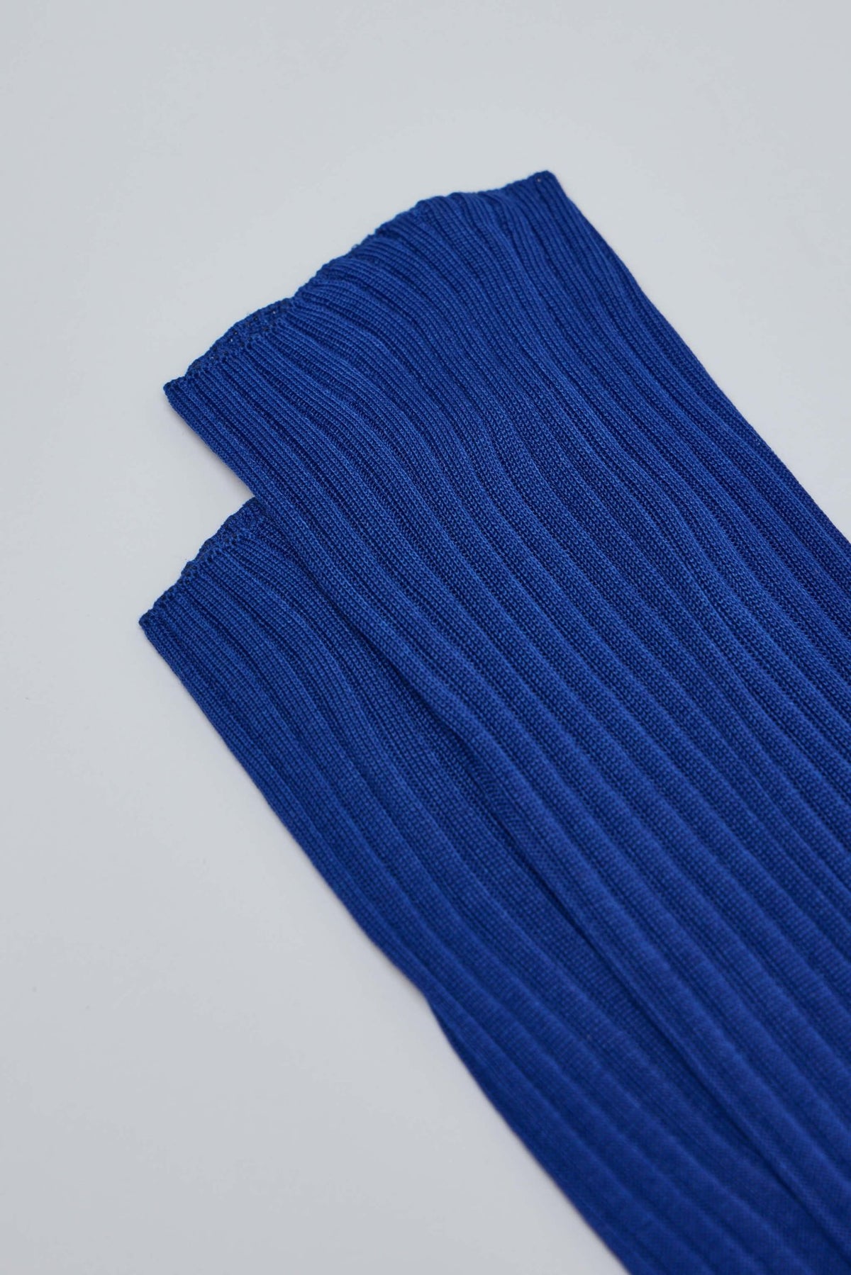 Model wearing blue Sofie D'Hoore knee-high socks with elastic top band