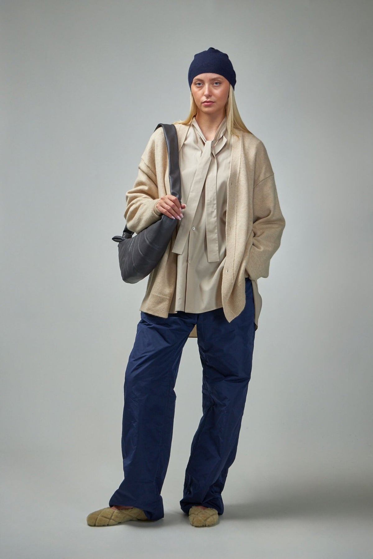 Close-up view of padded detailing and four pocket design on wide-leg pants