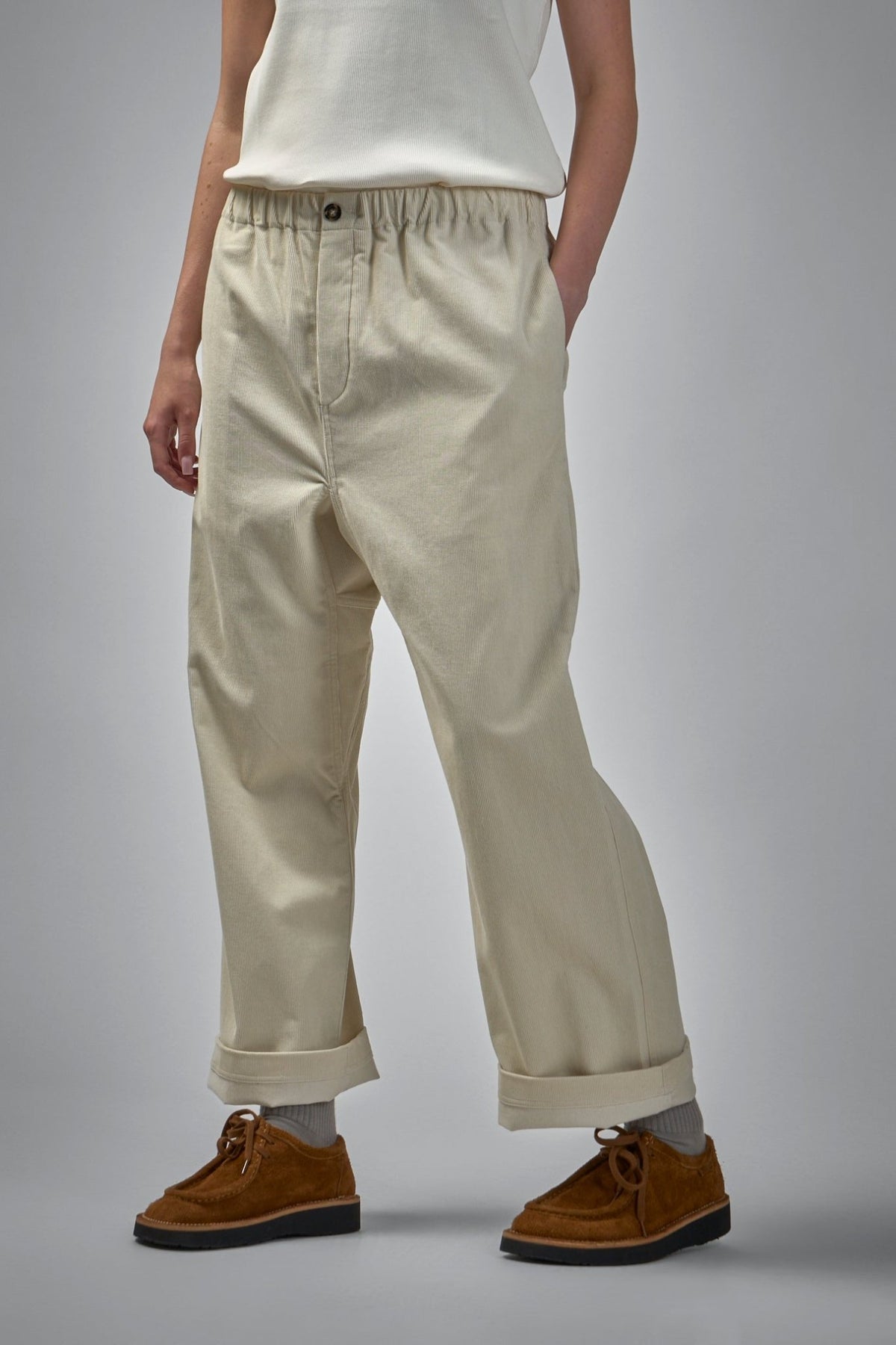 Back view of wide-leg pants showing patch pocket and relaxed fit