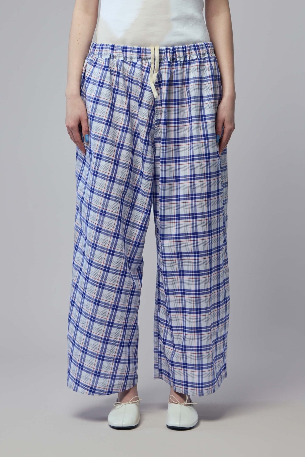 Blue plaid wide-leg pants showing relaxed fit and full-length silhouette