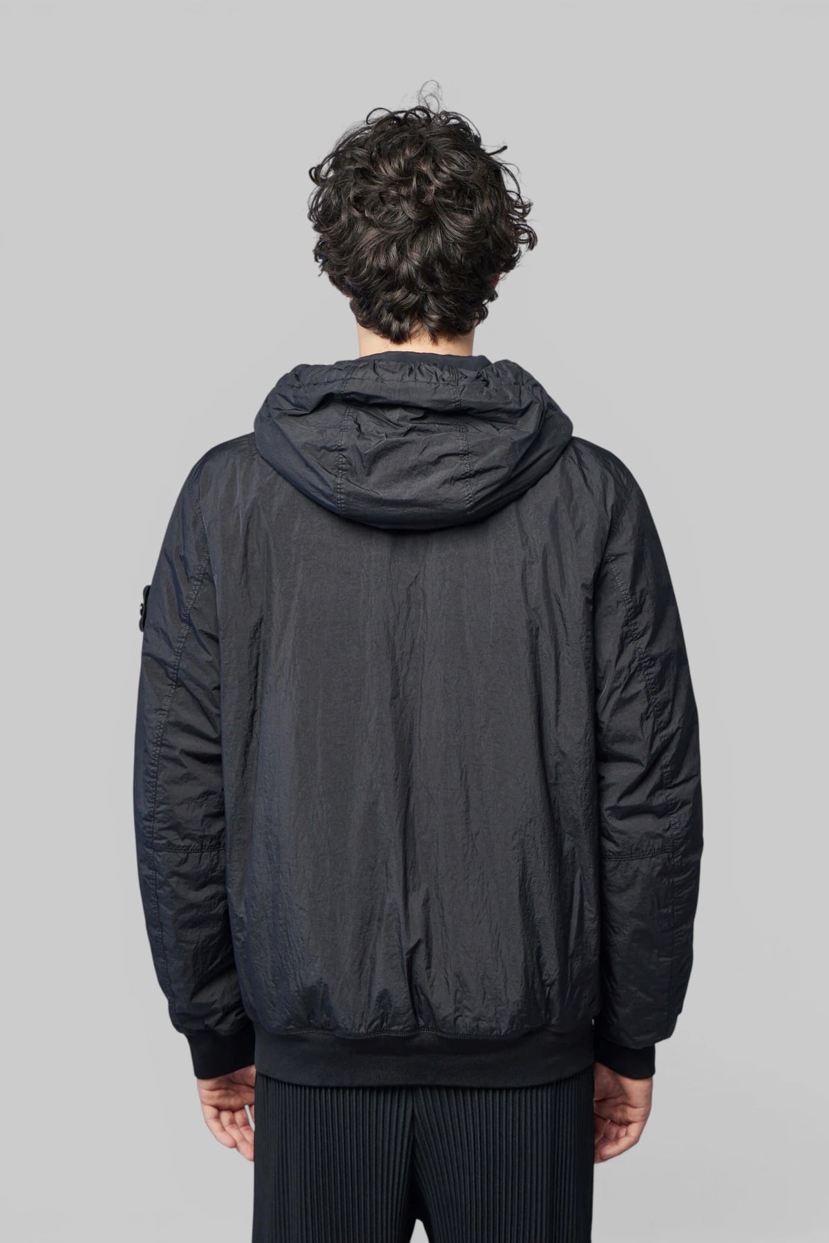 Model wearing Stone Island hoodie with casual outfit