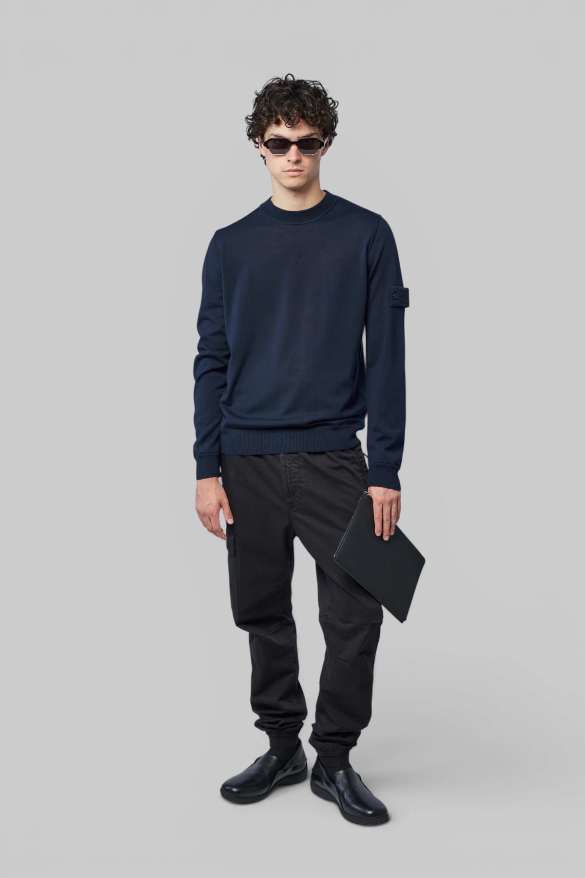 Close-up of sleeve patch detail on Stone Island crew neck sweater
