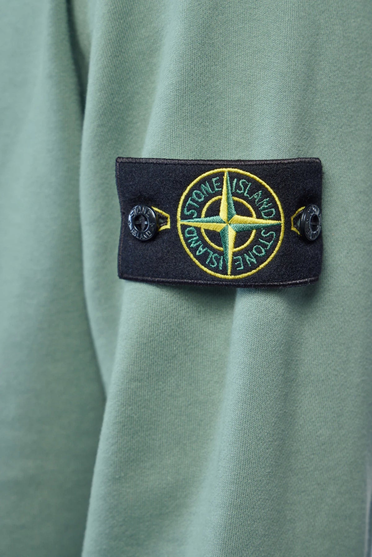 Stone Island sweatshirt detail shot showing cotton fabric texture