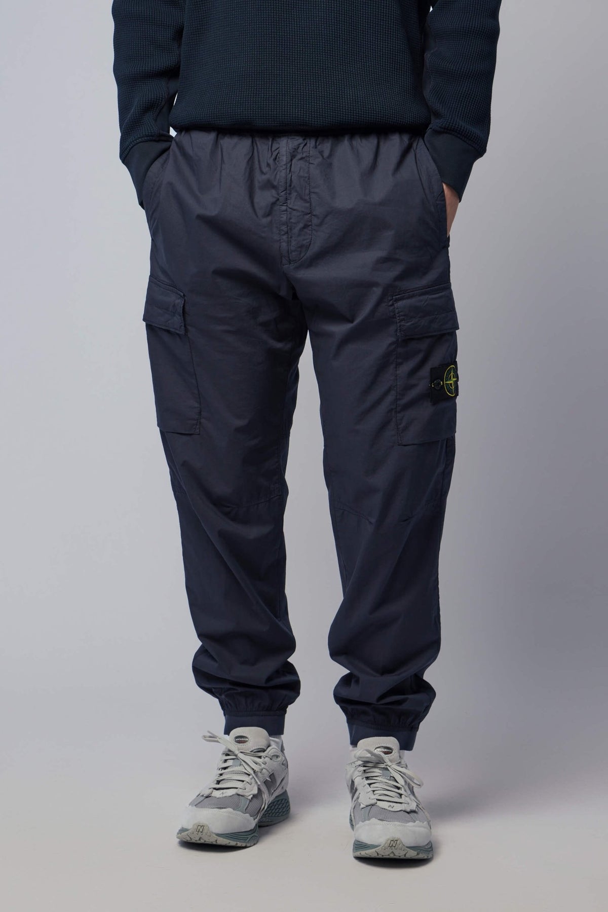 Stone Island cargo pants in dark tone with multiple pockets and elasticated cuffs