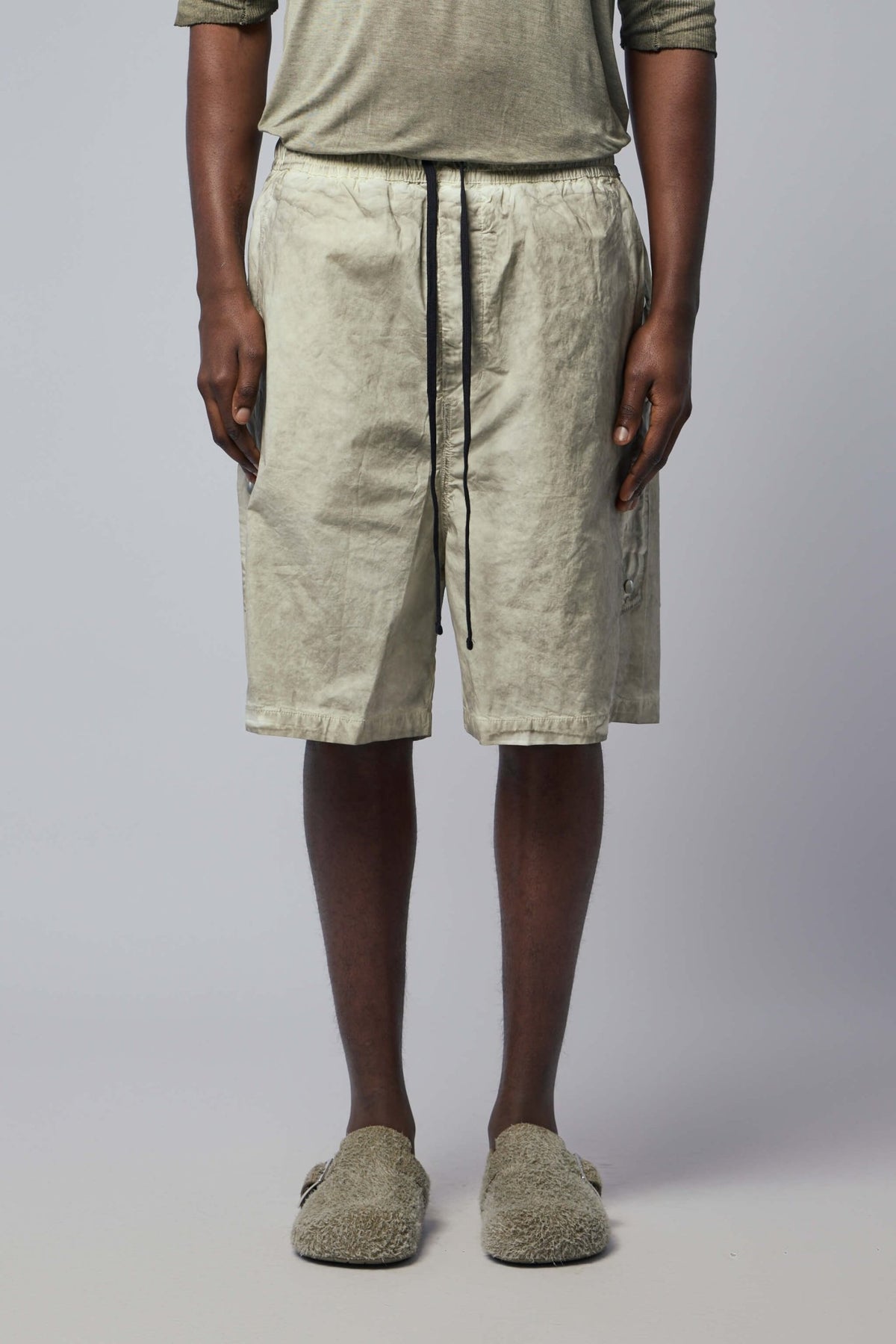 Close-up view of elastic waistband and drawstring closure on cargo pants
