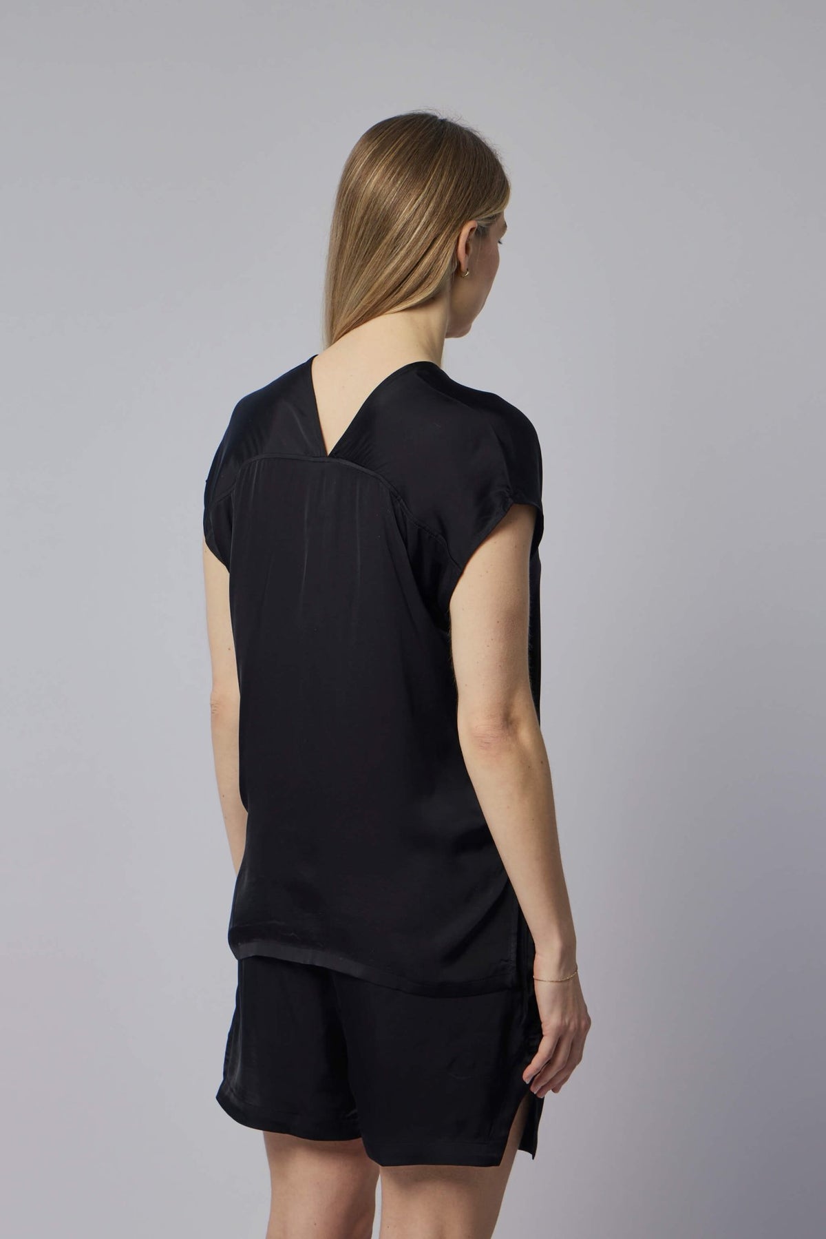 Detail shot of V-neckline construction on Thom Krom blouse