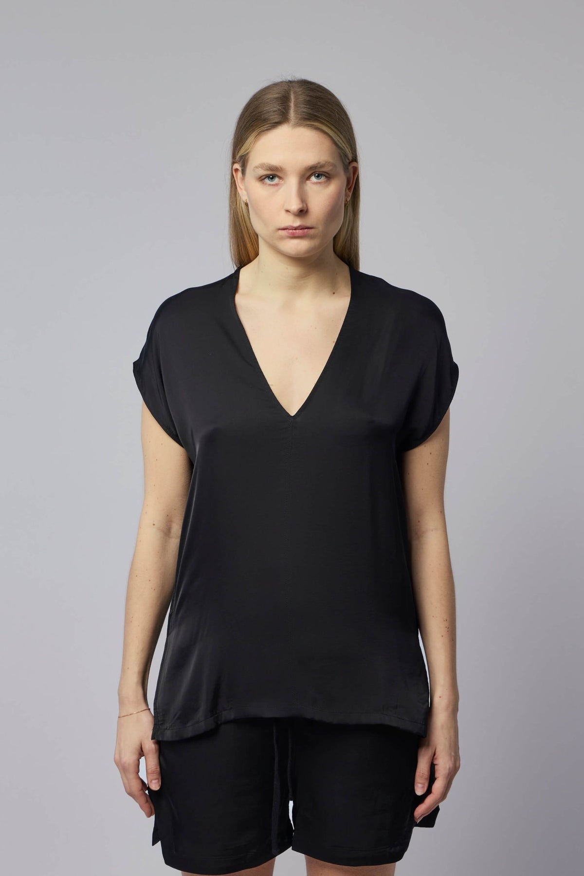 Close-up of black viscose blouse showing smooth fabric texture