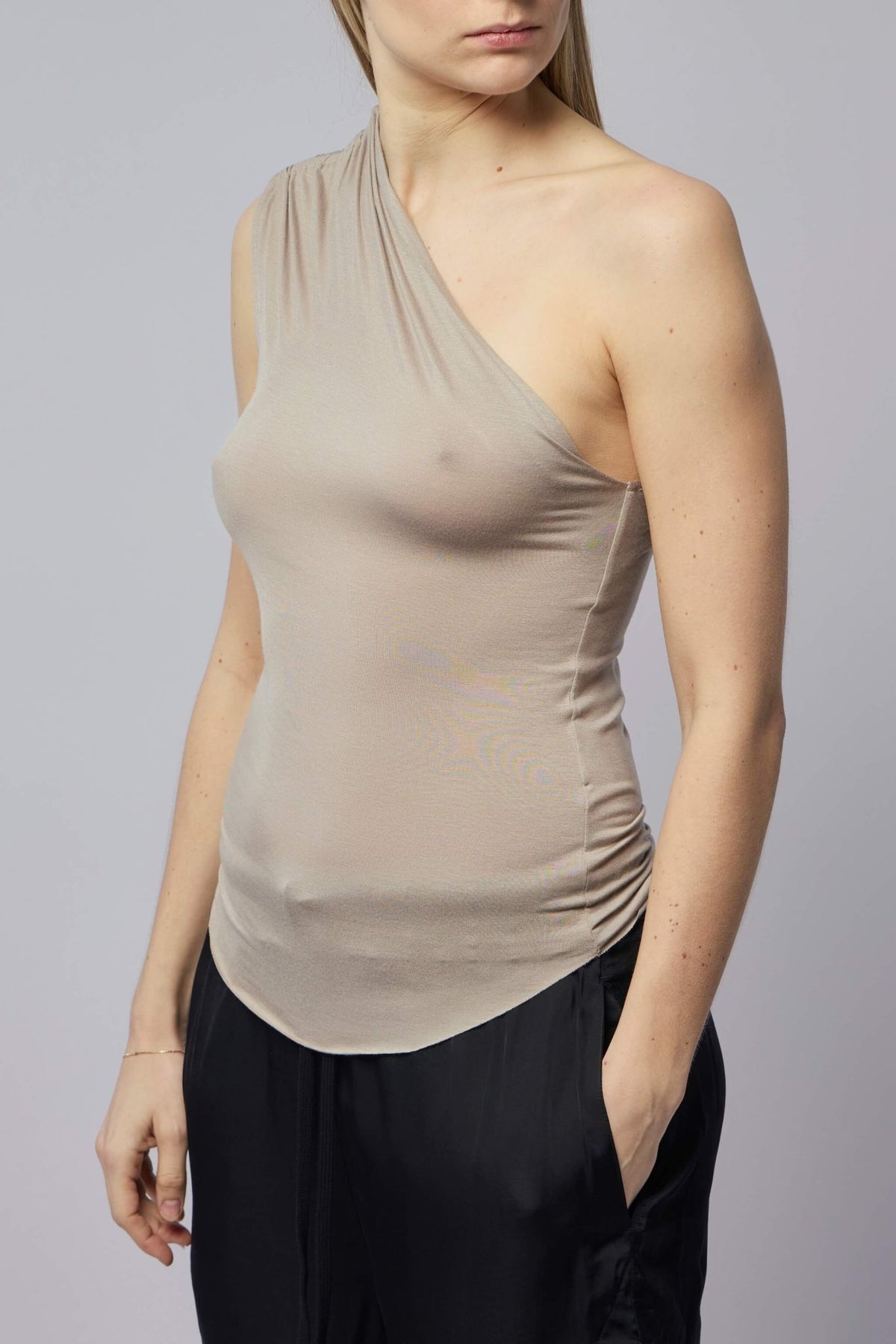 Model wearing fitted one-shoulder Thom Krom top