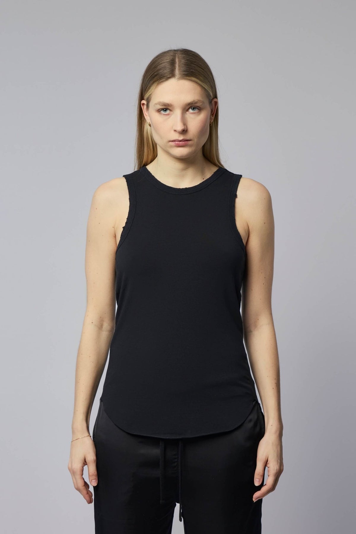 Close-up detail of ribbed side panel construction on Thom Krom tank top