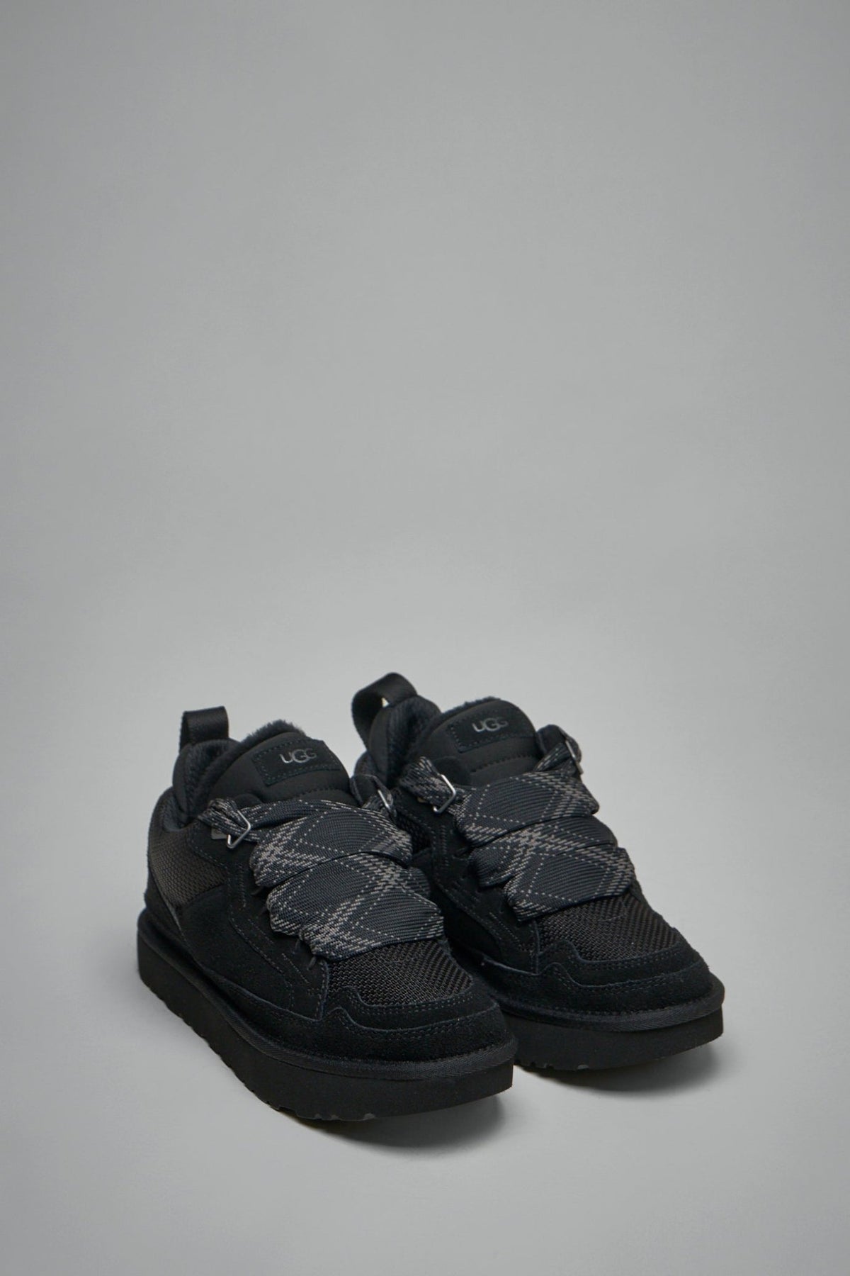 Side view of UGG Lowmel sneakers showing textured sole and lace-up design