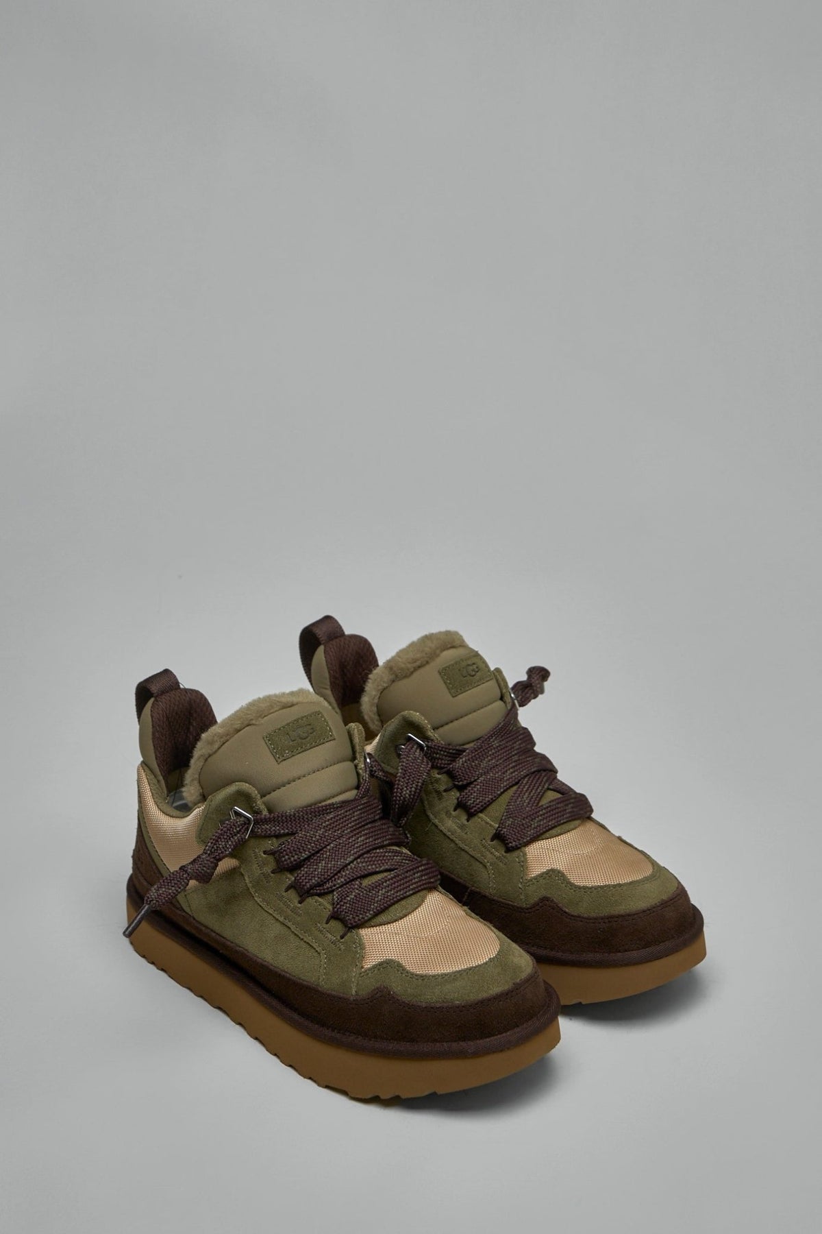 Side view of UGG Lowmel sneakers showing contrast stitching detail