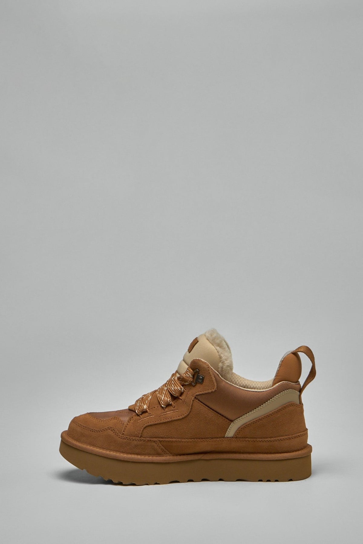 Side profile of UGG sustainable sneakers with shearling collar detail