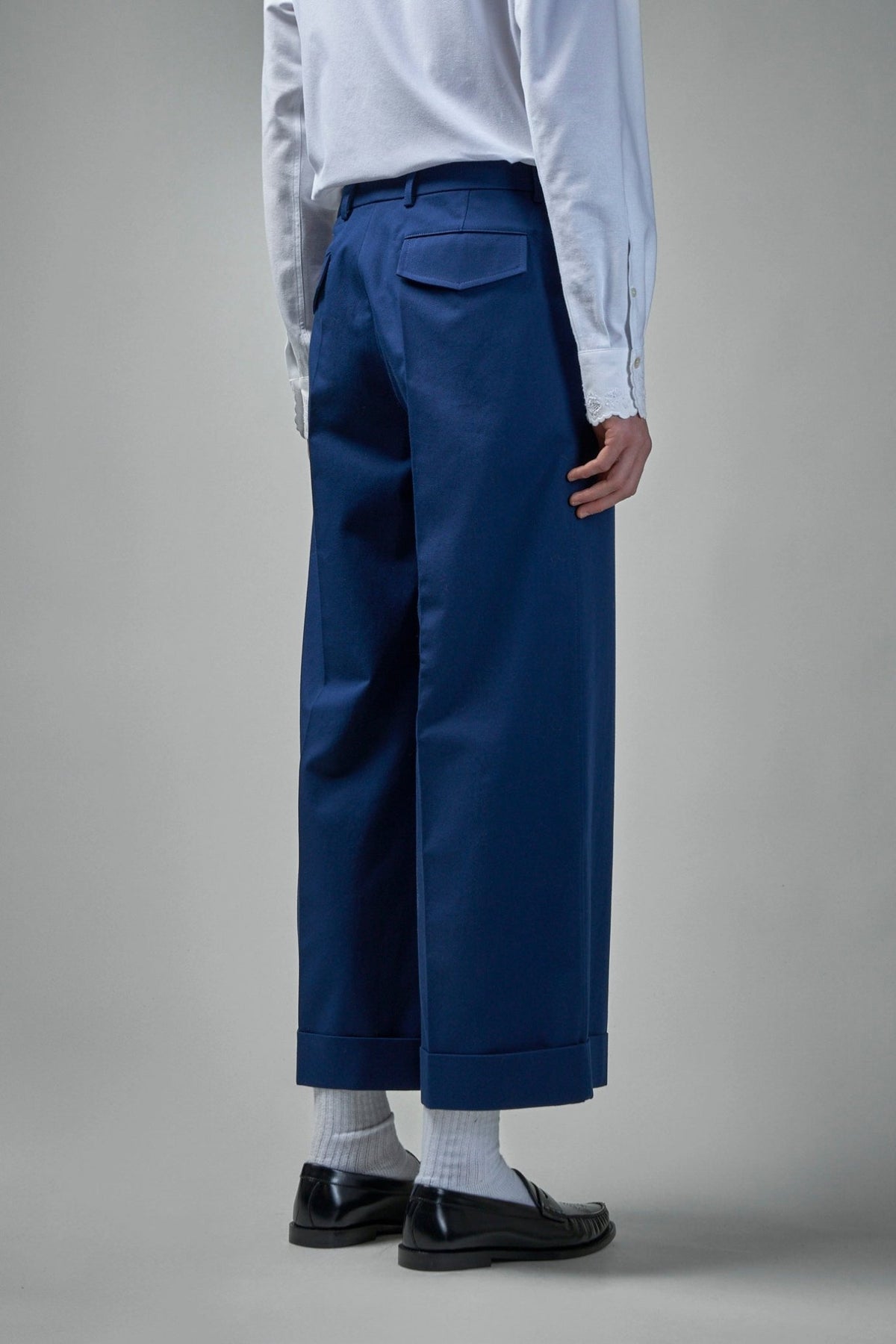 Back view showing rear pockets and tailored fit of Valentino pants