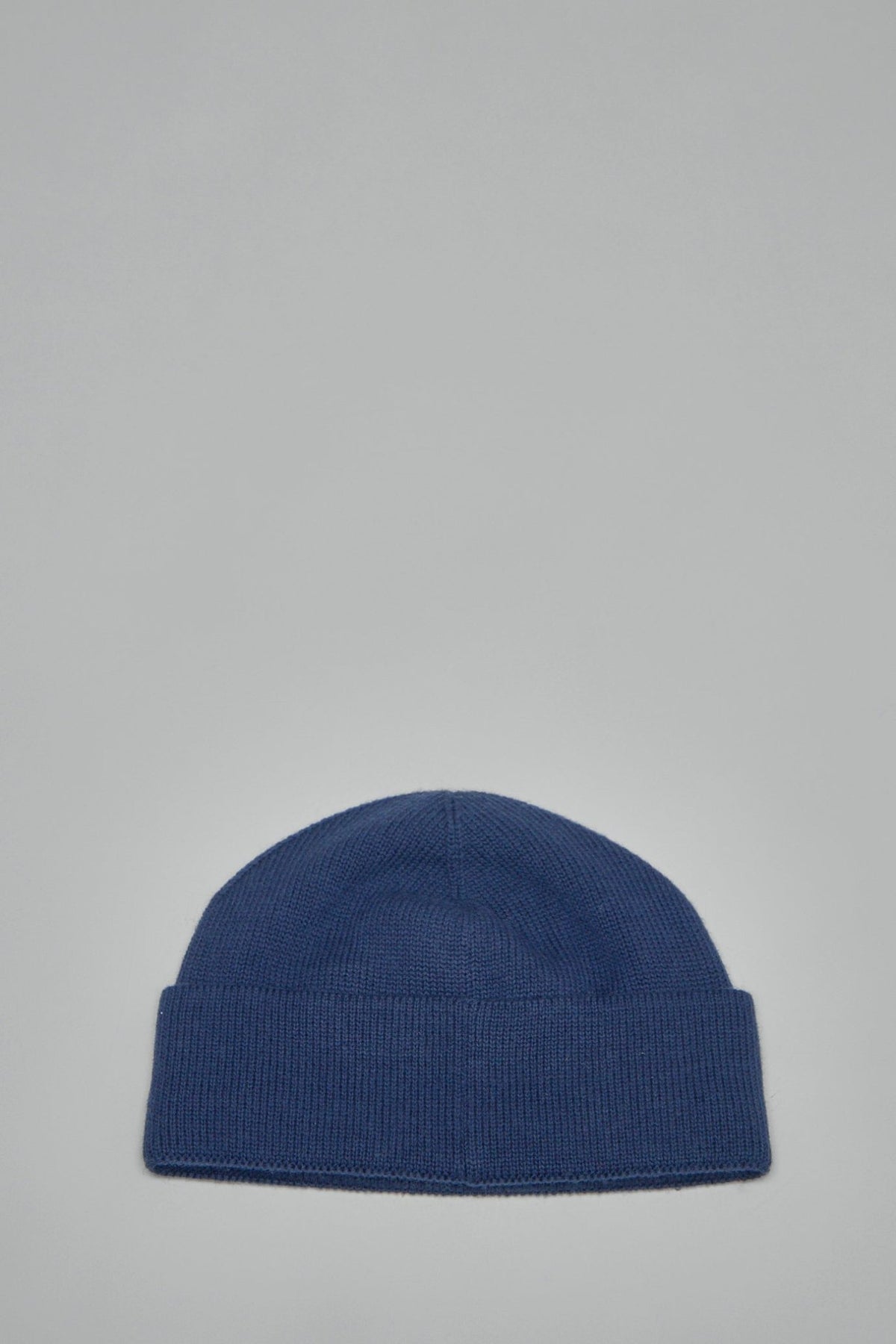Close-up of CHEZ VALENTINO logo embroidery on ribbed knit beanie