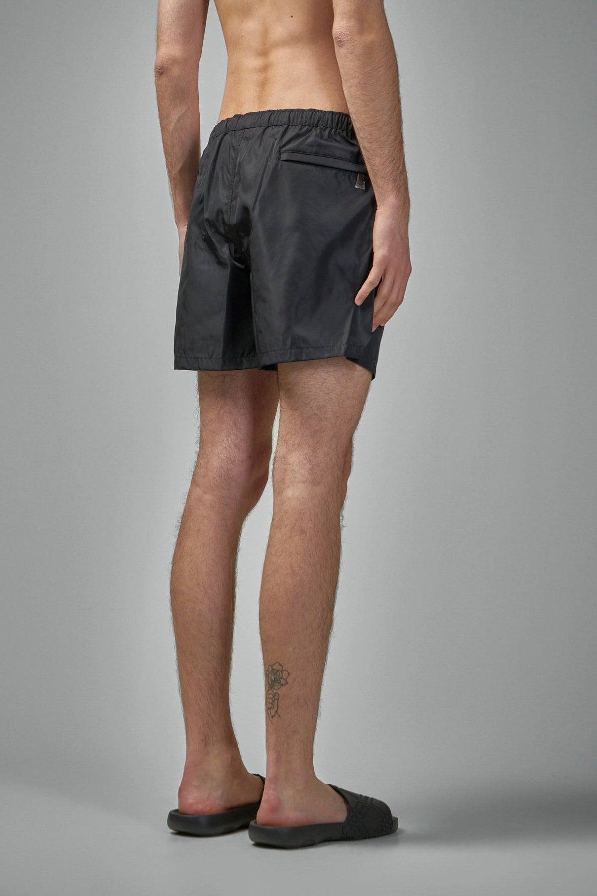 Back view of Valentino swimsuit showing elasticated waistband and pocket detail