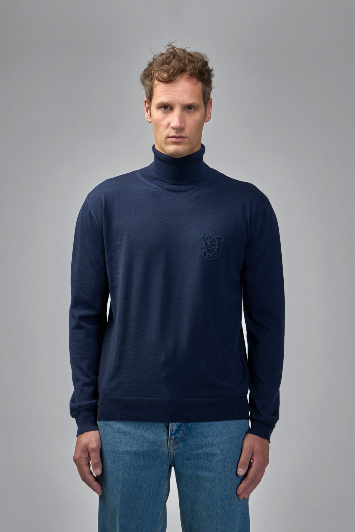 Side view showing fitted silhouette of navy wool turtleneck