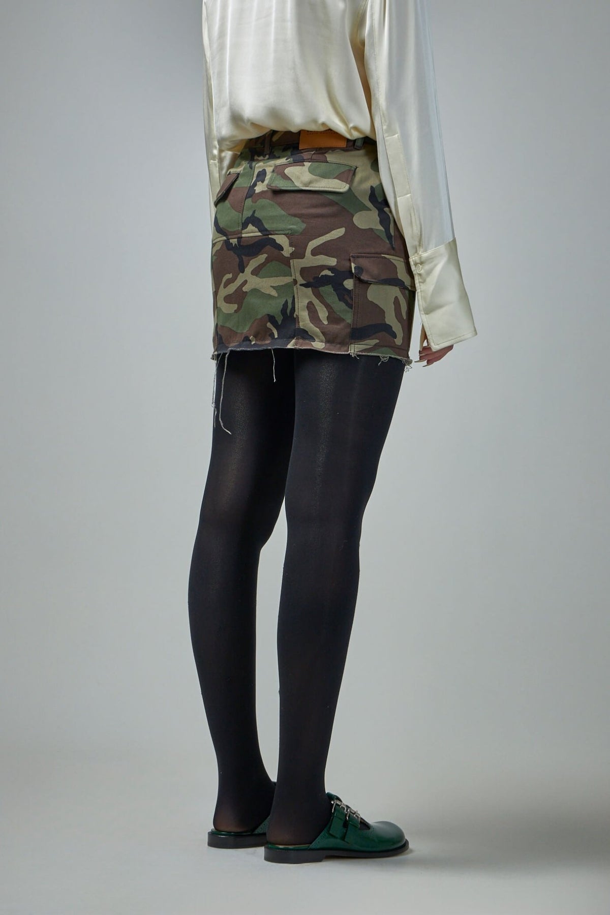 Model wearing Vetements cargo camo mini skirt showing fit and styling