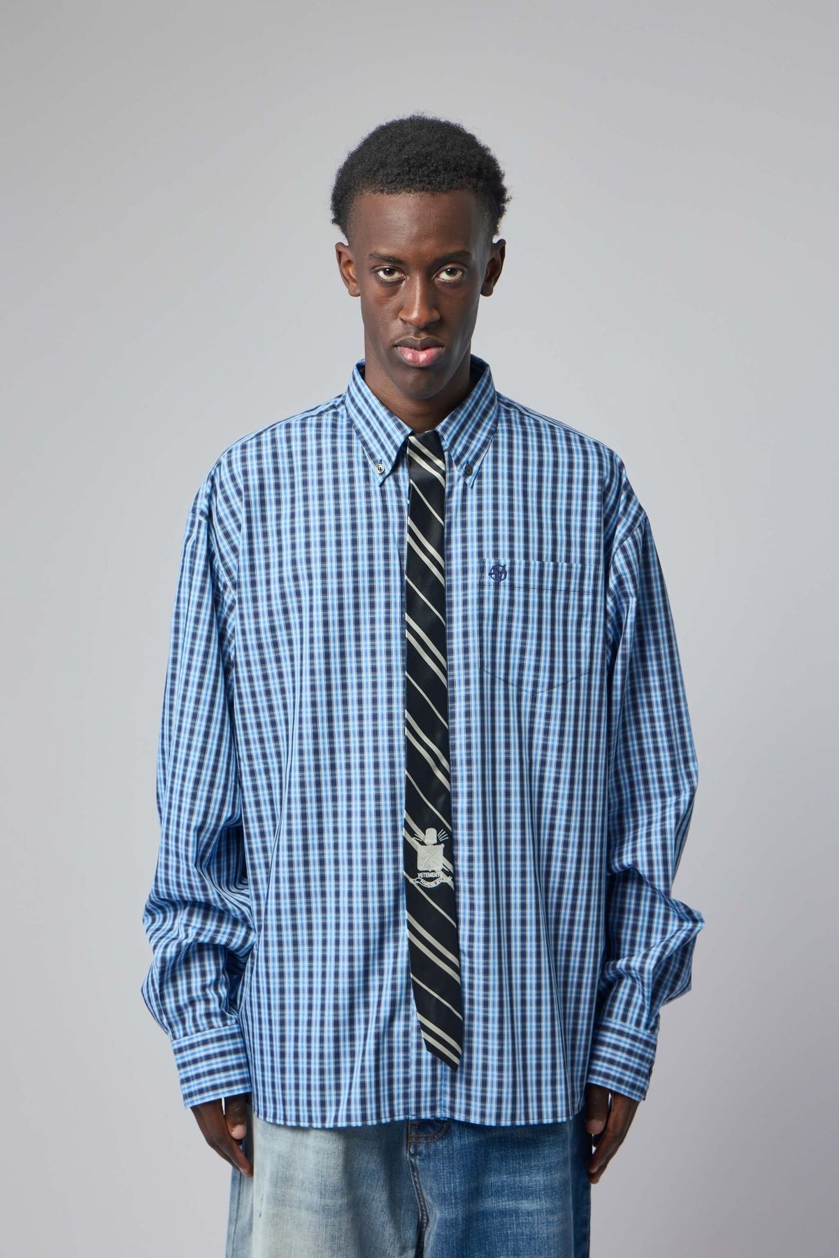men - Close-up of Vetements oversized shirt showing attached polyester tie accent