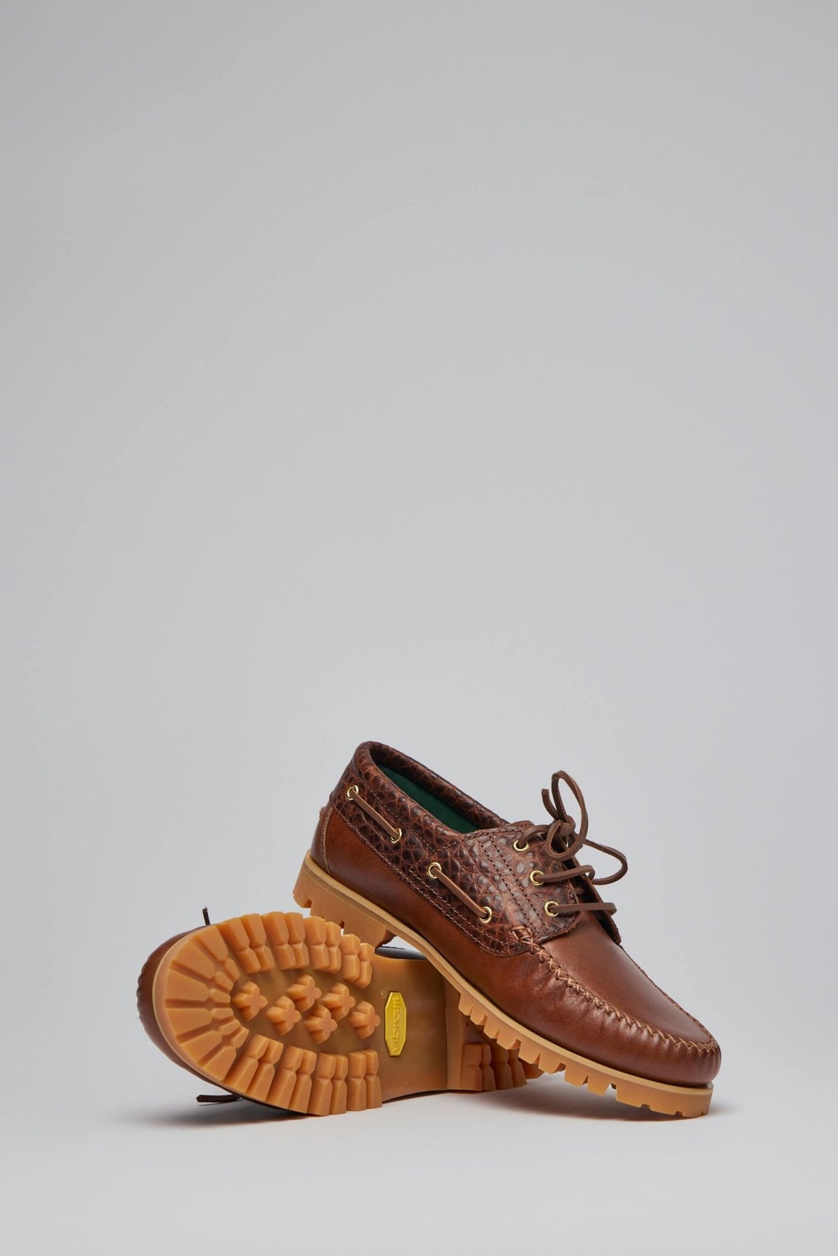Full view of brown leather boat shoes with classic nautical styling