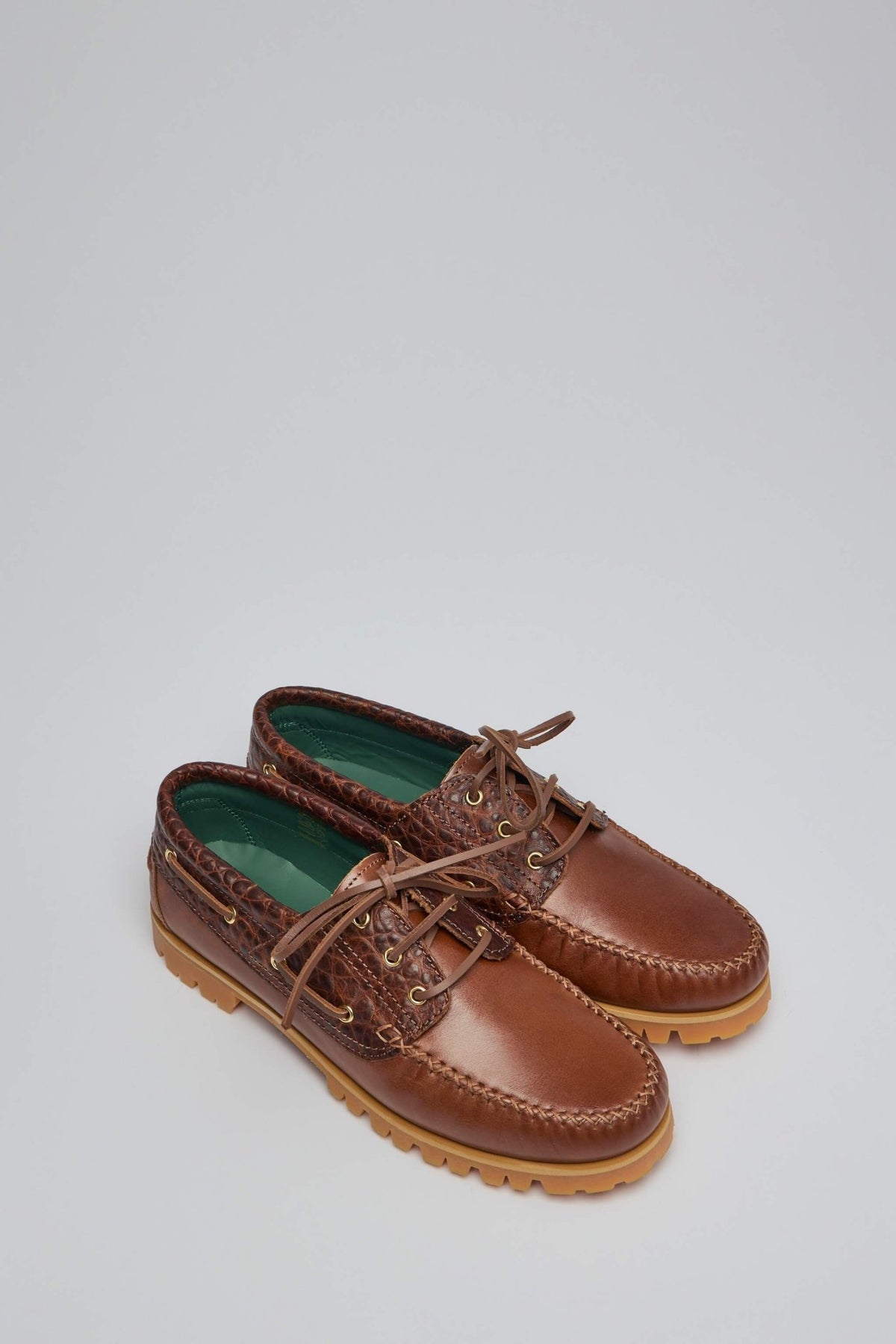 Close-up view of premium leather boat shoe with gold eyelets and lace-up design