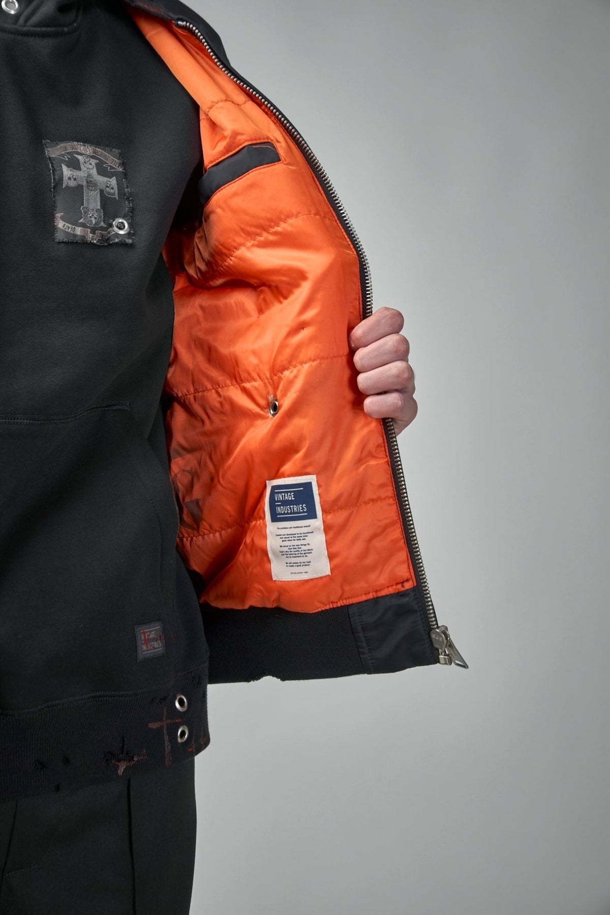 Premium nylon fabric texture detail on black bomber jacket