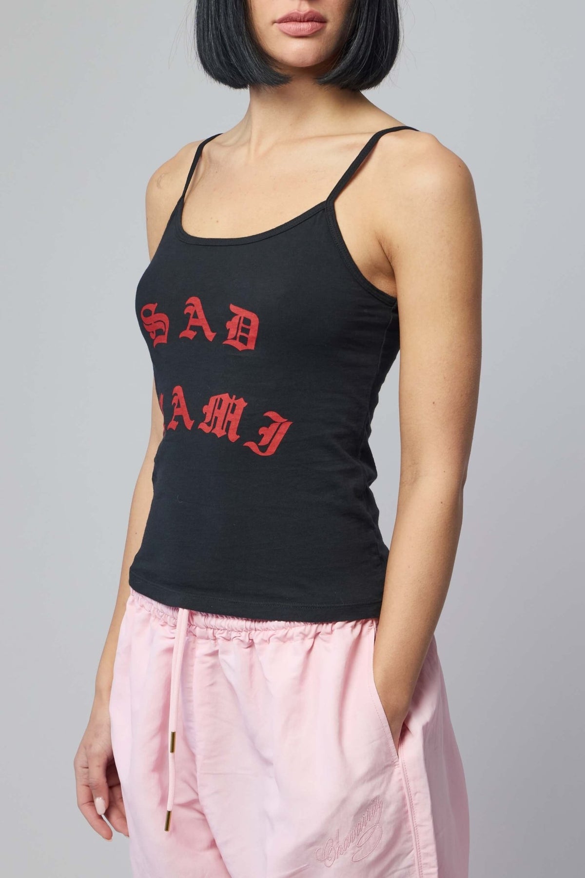Model wearing Willy Chavarria tank in contemporary streetwear styling