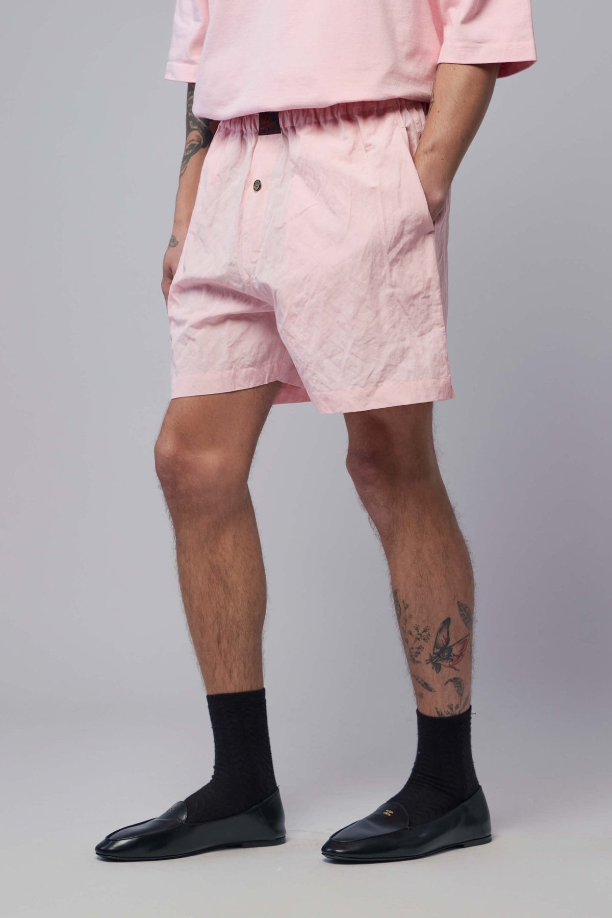Model wearing pink Willy Chavarria woven boxer shorts with relaxed fit
